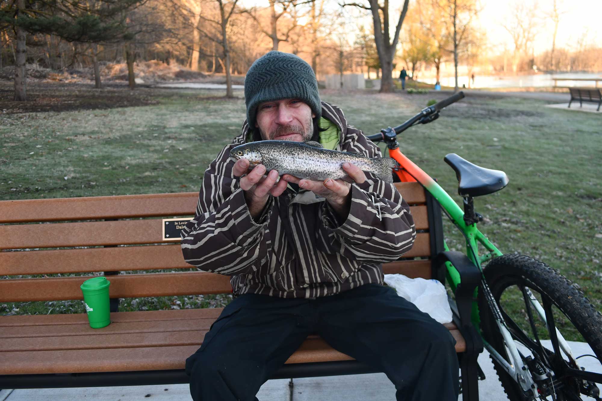 A man poses with a fish.