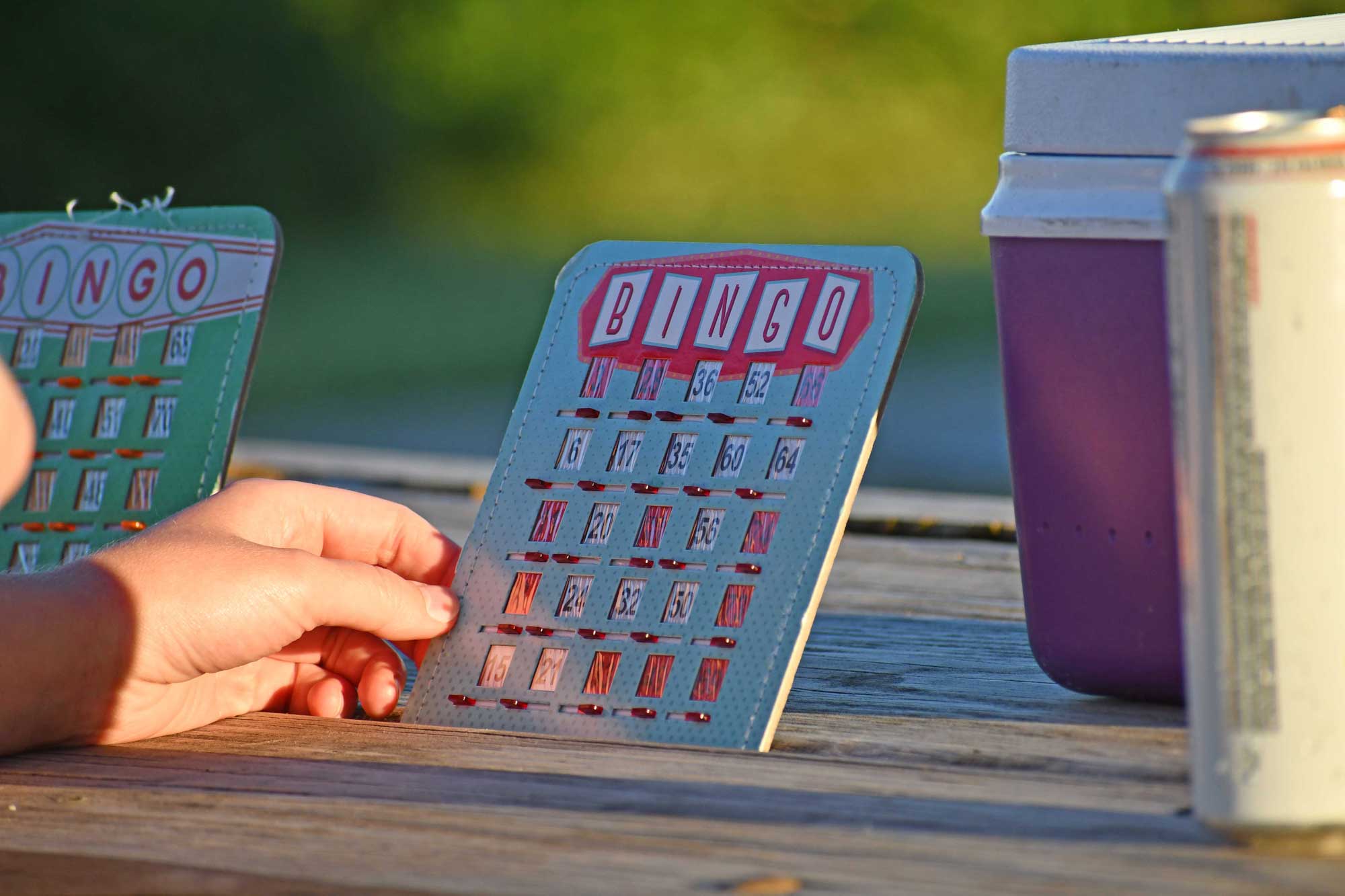 A closeup of a hand holding a bingo card.