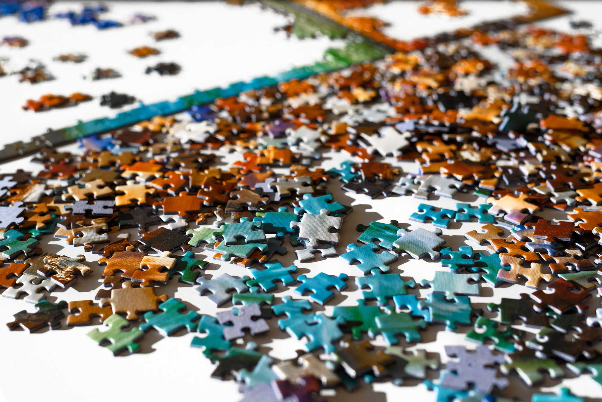 Colorful jigsaw puzzle pieces on a table. 