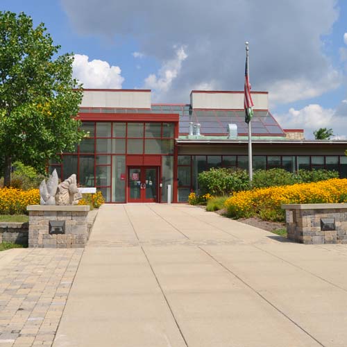 The exterior of a visitor center in summer.
