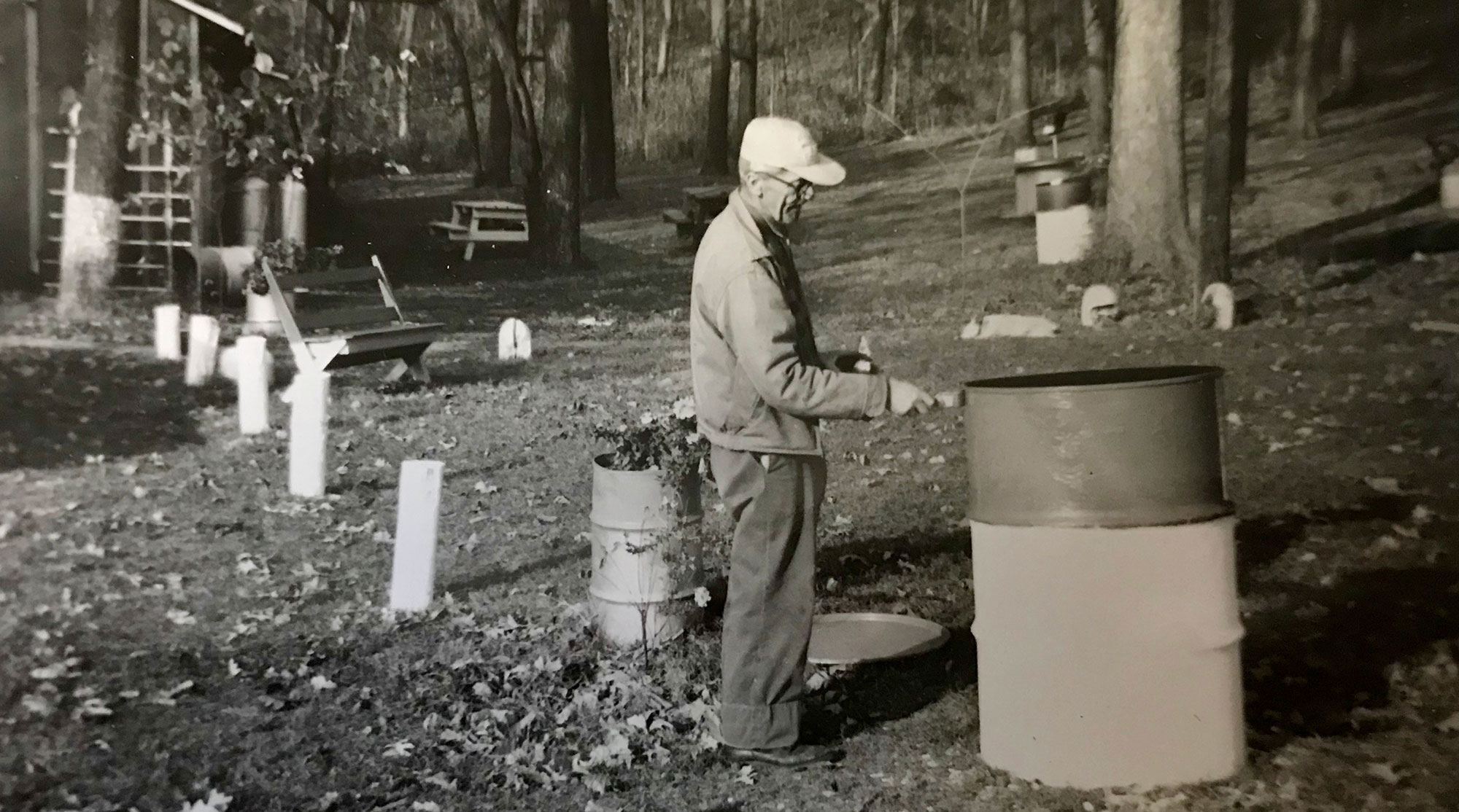 Arthur Sage painting an oil drum used as garbage receptacles in the preserve.