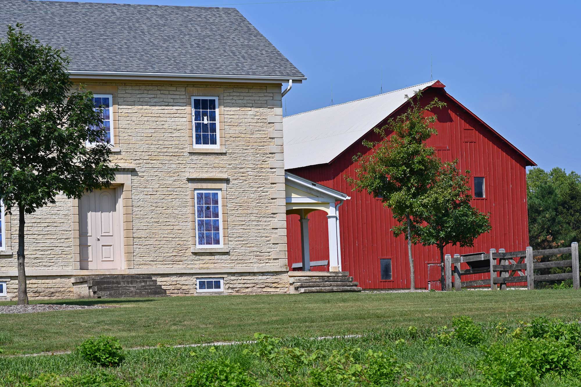 A large red barn and farmhouse.