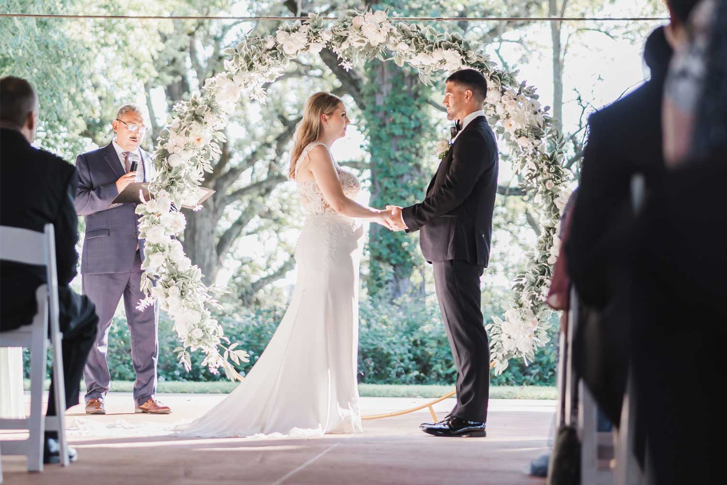 Couple standing at the front of a wedding during the ceremony.