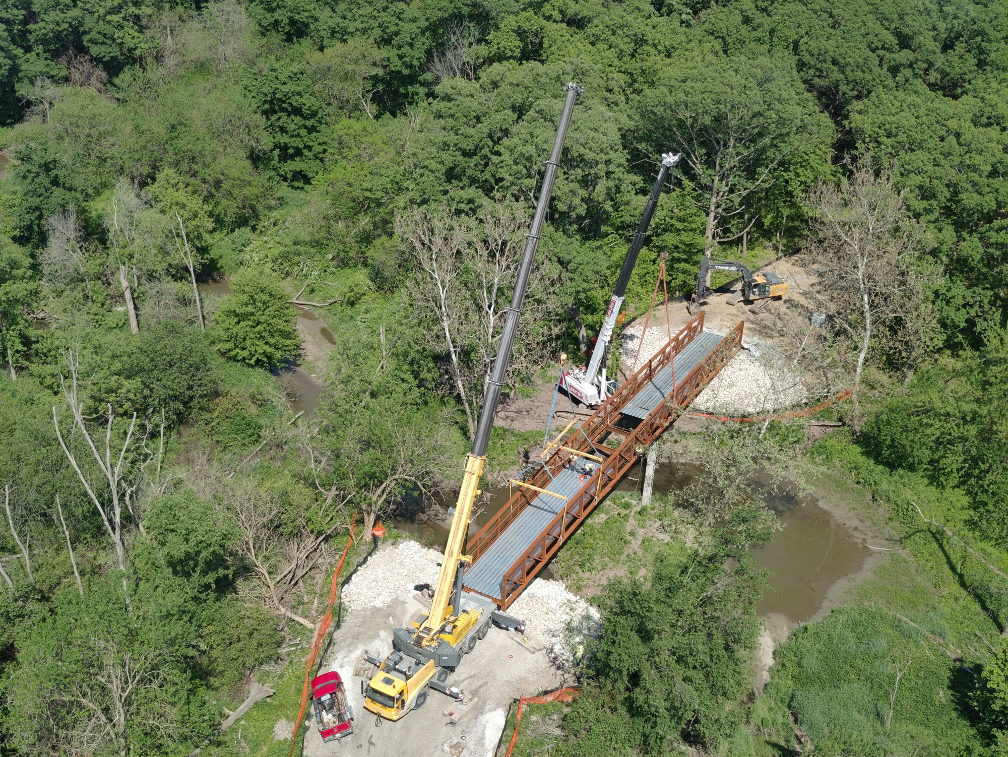 Aerial view of walking bridge being installed.