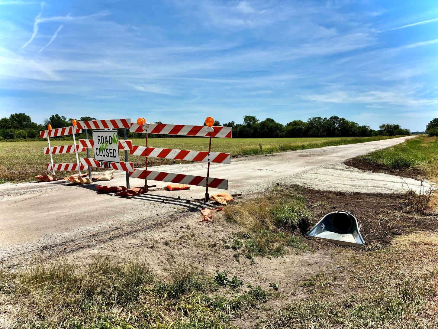 a road closed sign on a dirt road