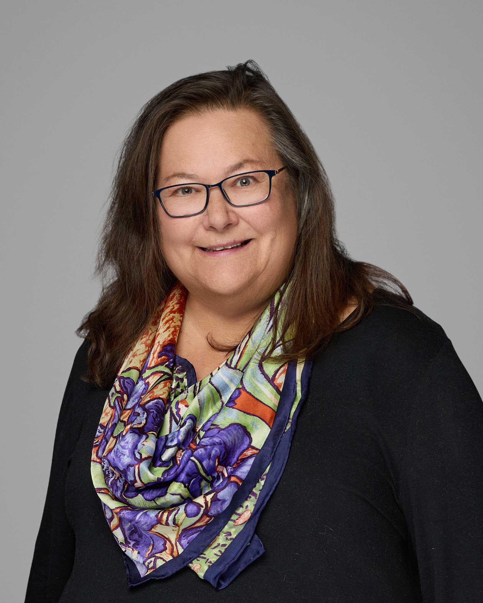 a woman wearing glasses and a scarf