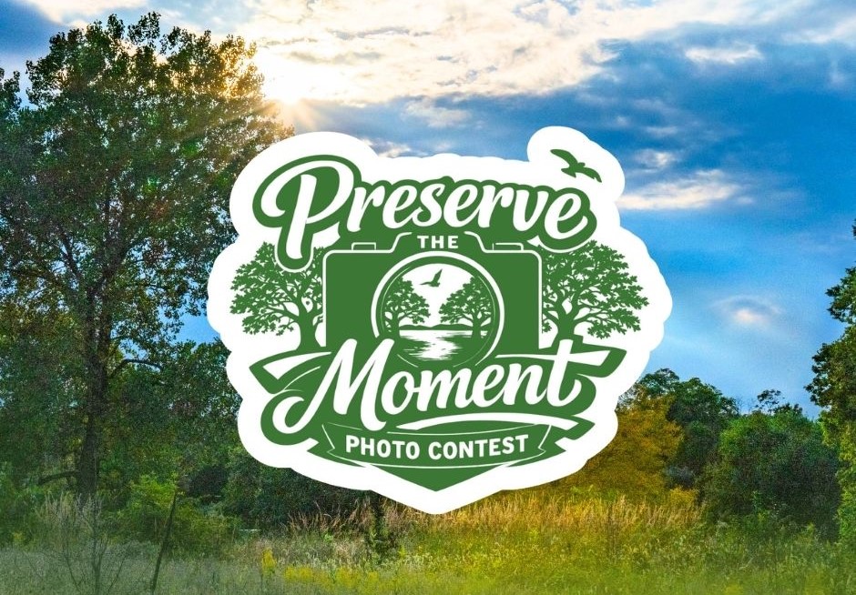 A logo saying Preserve the Moment laid over a photo of an outdoor scene with green trees and a blue sky.