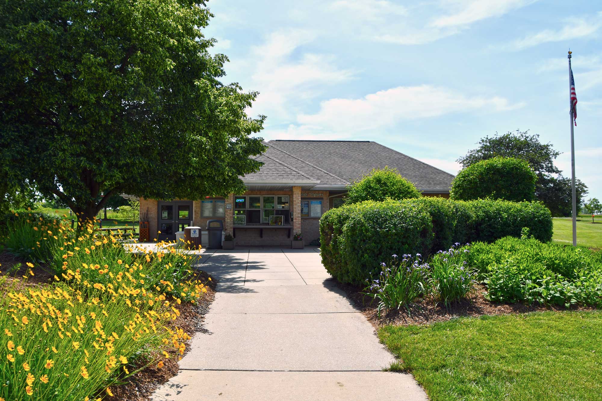 The exterior of a visitor center in summer.