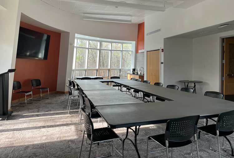 a room with a large table and chairs