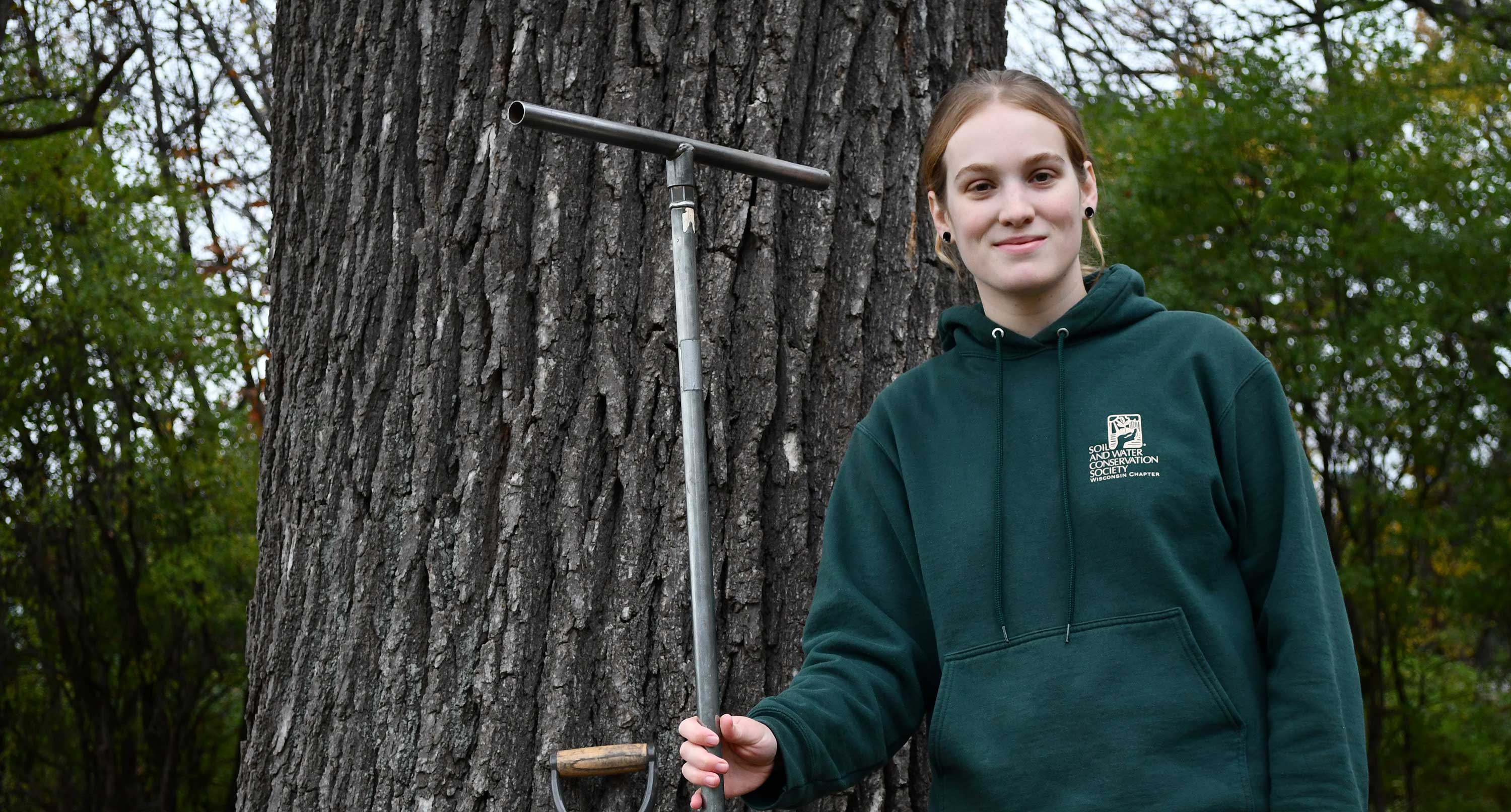 Roz Remsen standing in front of a white oak tree.