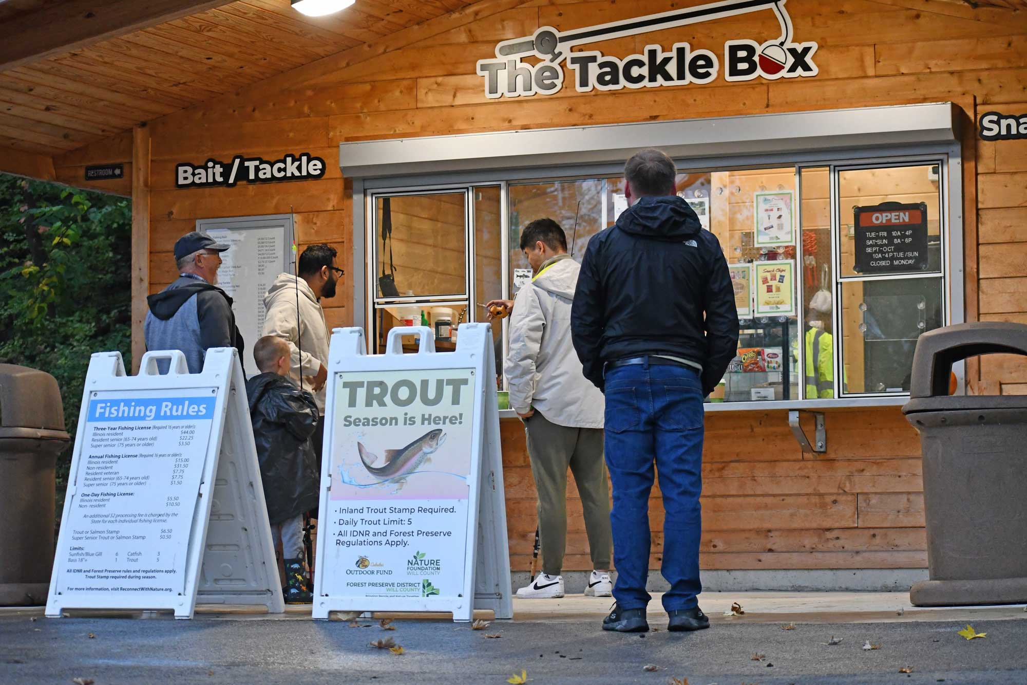 People standing in front of a bait stand.