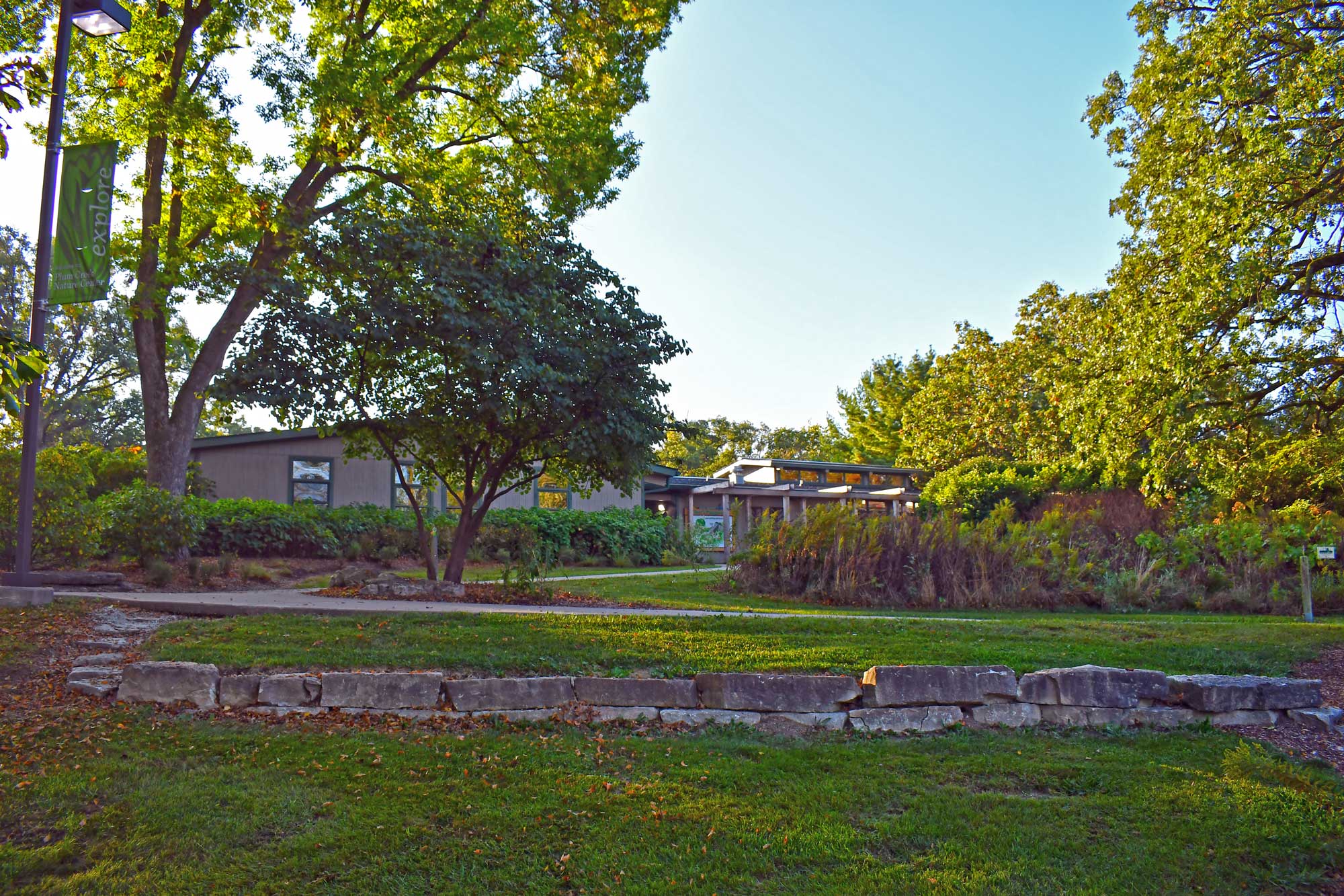 Plum Creek Nature Center from the outside with trees nearby.