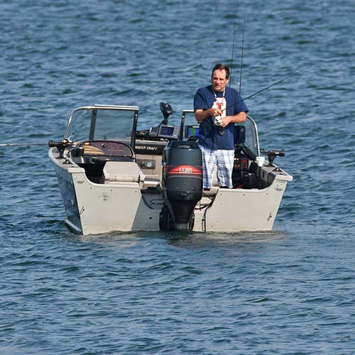 A man fishing in a boat.