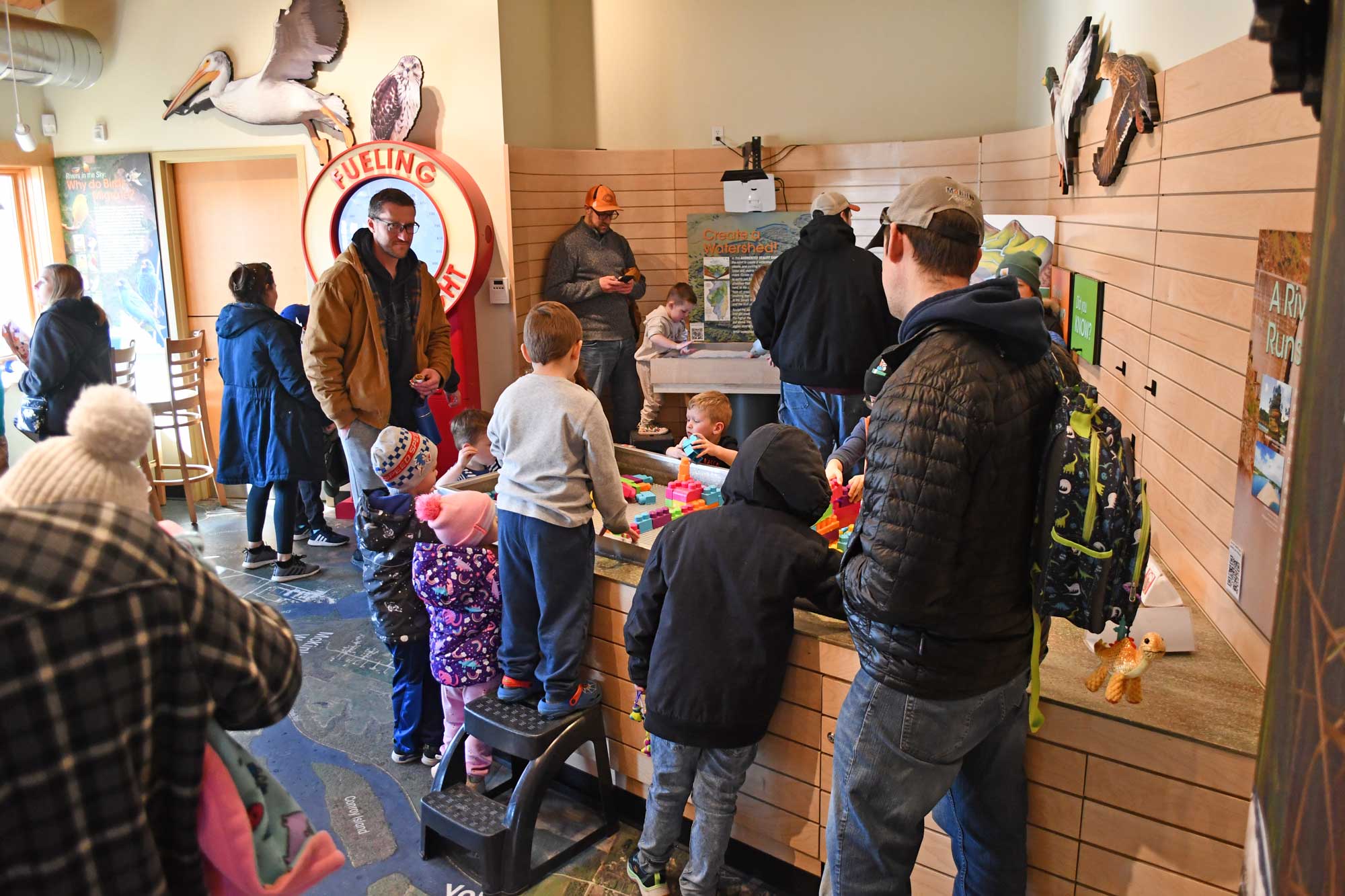 Visitors using interactive exhibits.