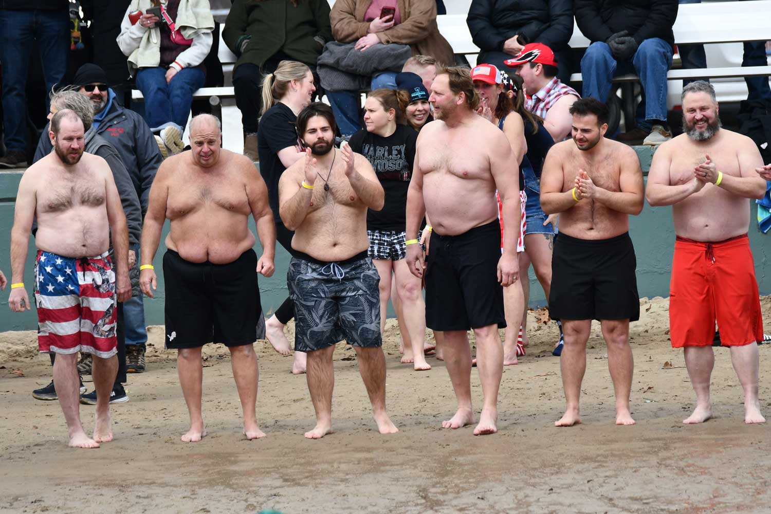 Shirtless people on a beach