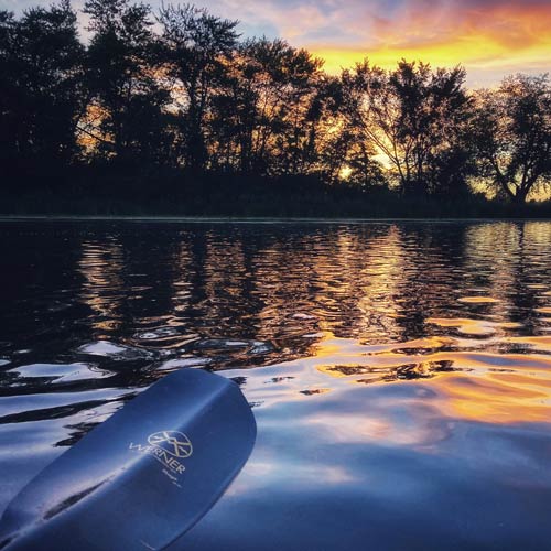 A view of the setting sun on the water.