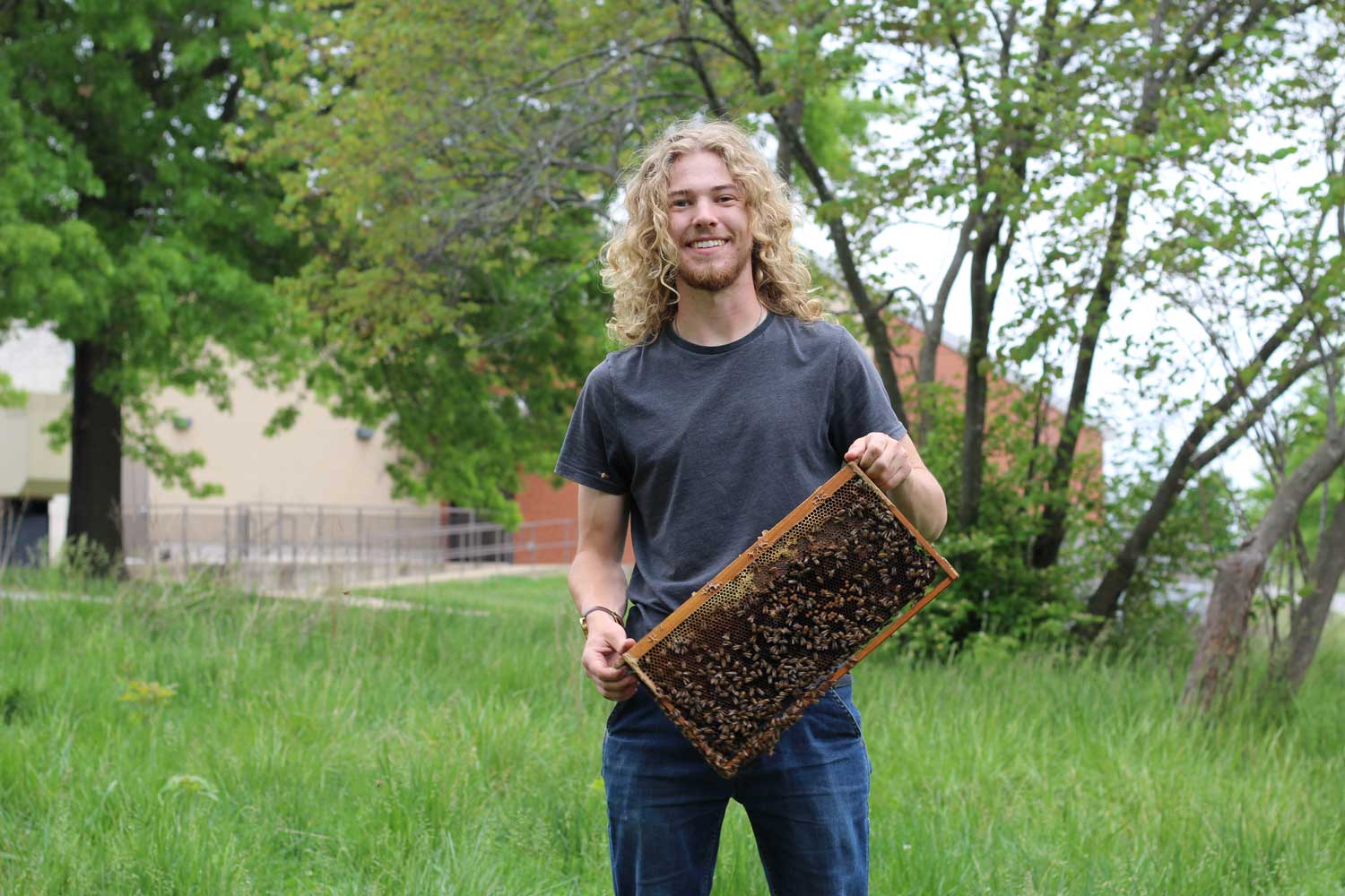 a man holding a box of bees