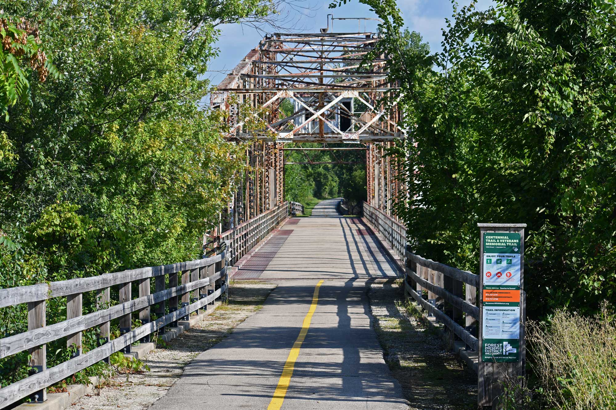 Bridge and bike path with trees in the background.