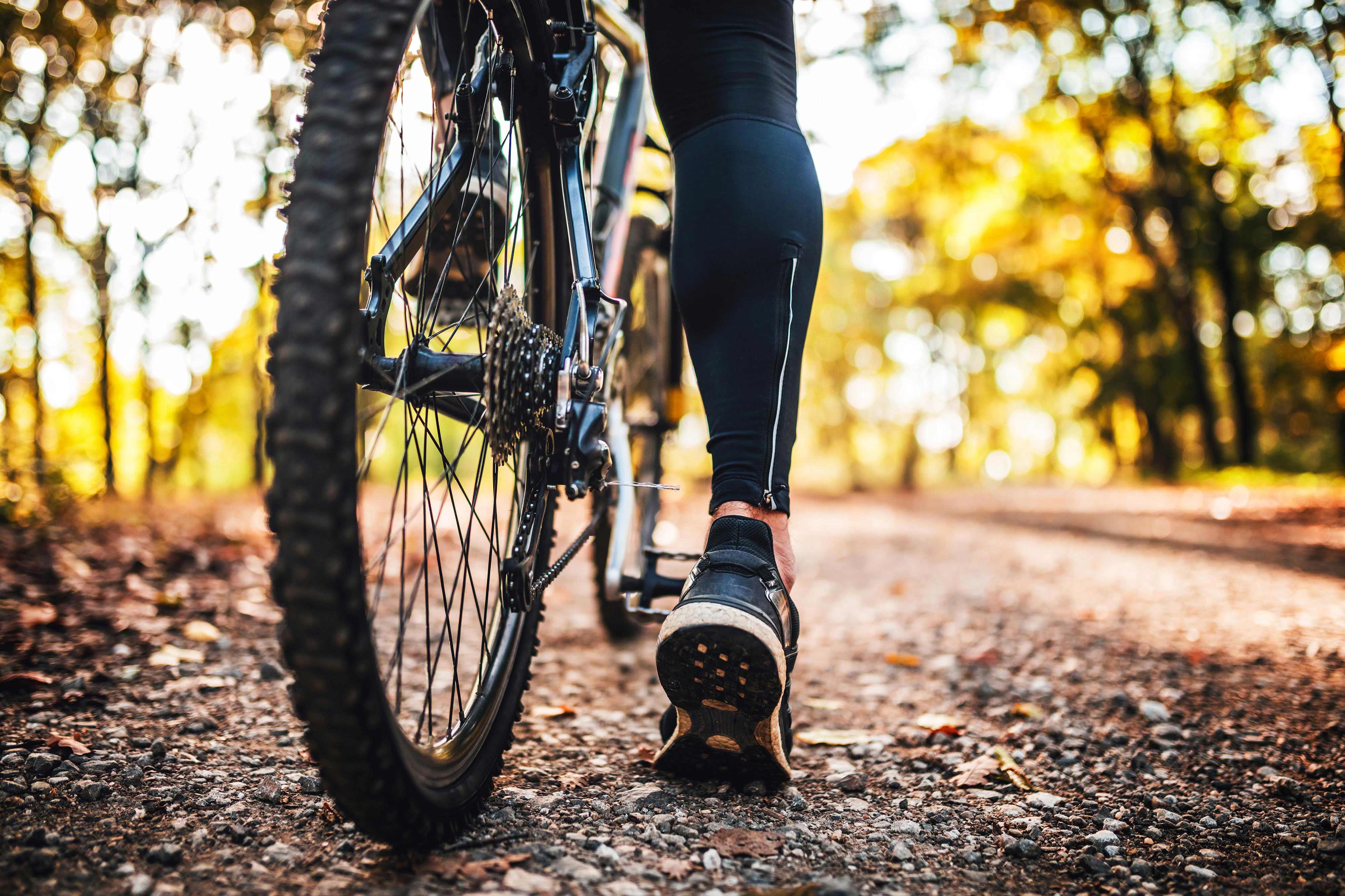 Close up of a bicyclist on a trail during fall.