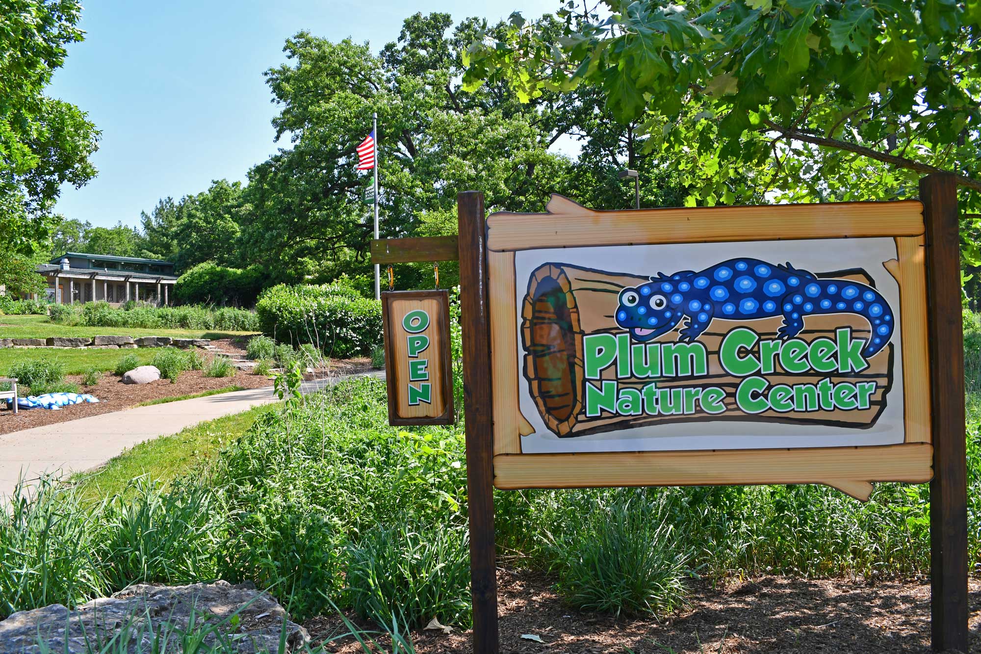 Nature center sign in front of building and trees.