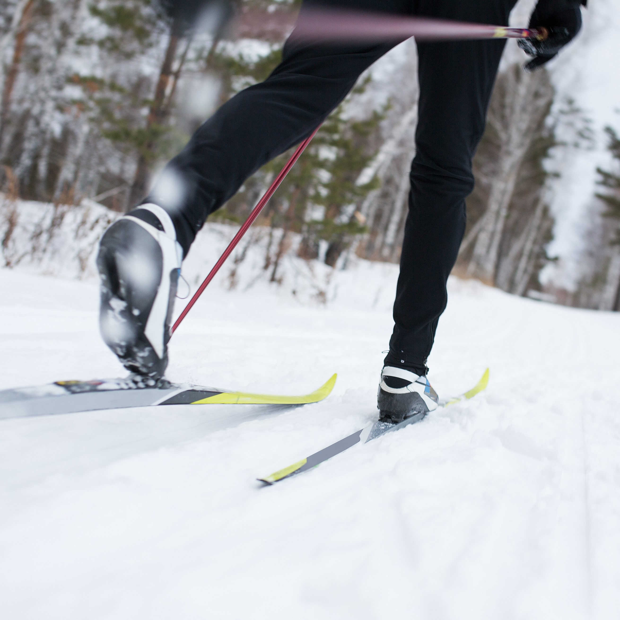 A cross-country skier on a snow-covered trail.