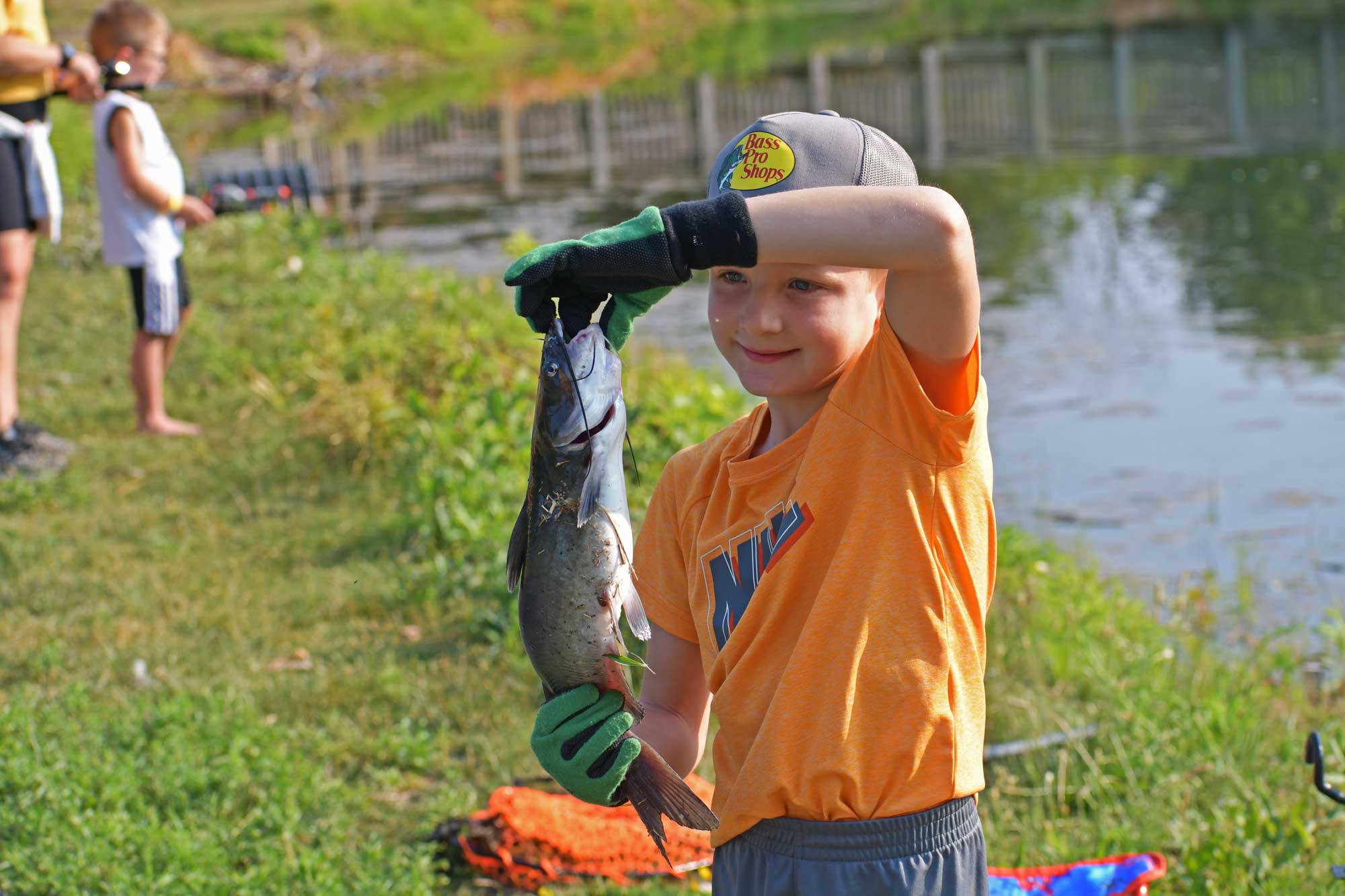 Child holding a fish they caught.