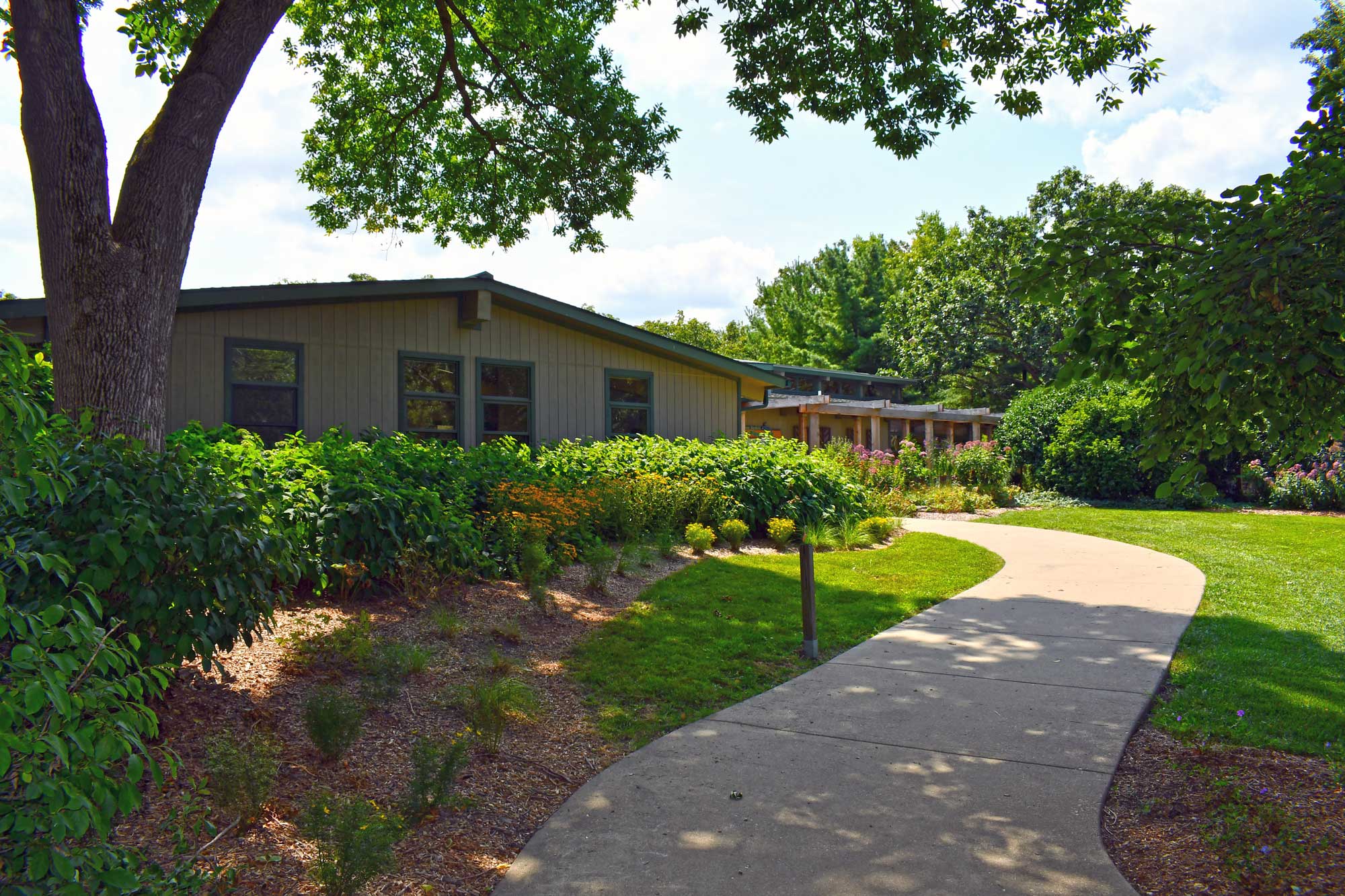 The exterior of a visitor center in summer.