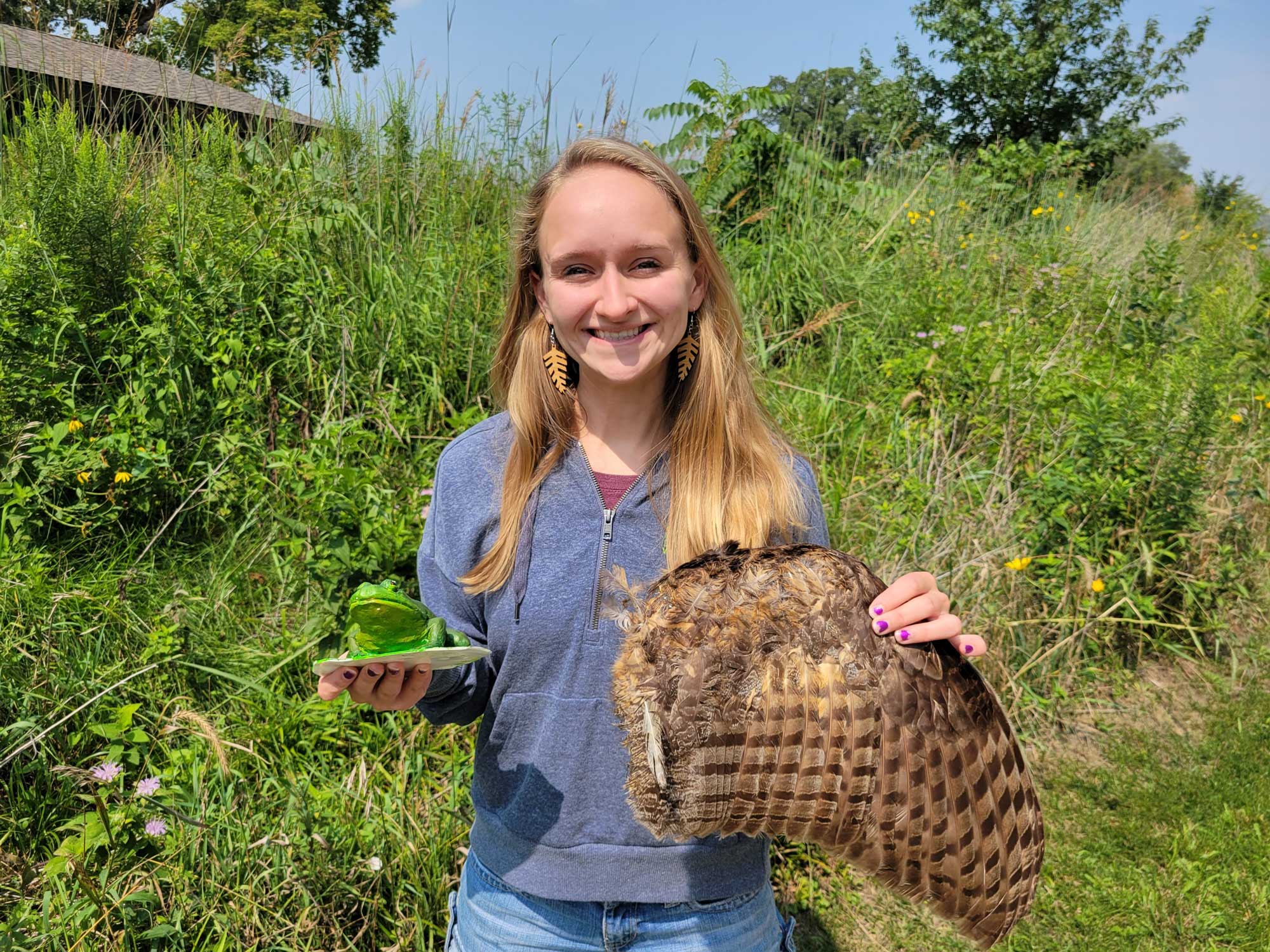 a woman holding a bird and a plate of food