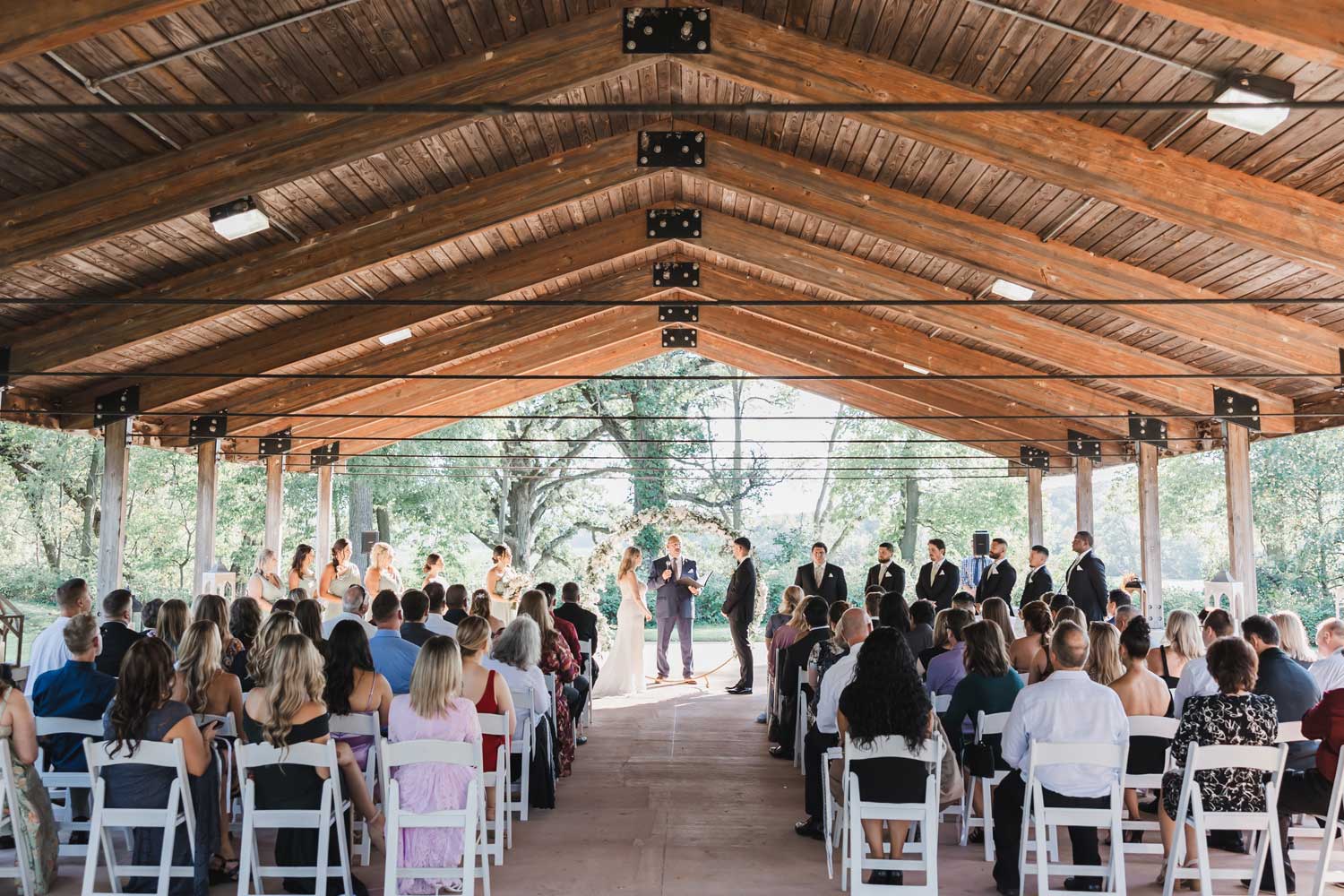 Couple standing at the front of a wedding during the ceremony.