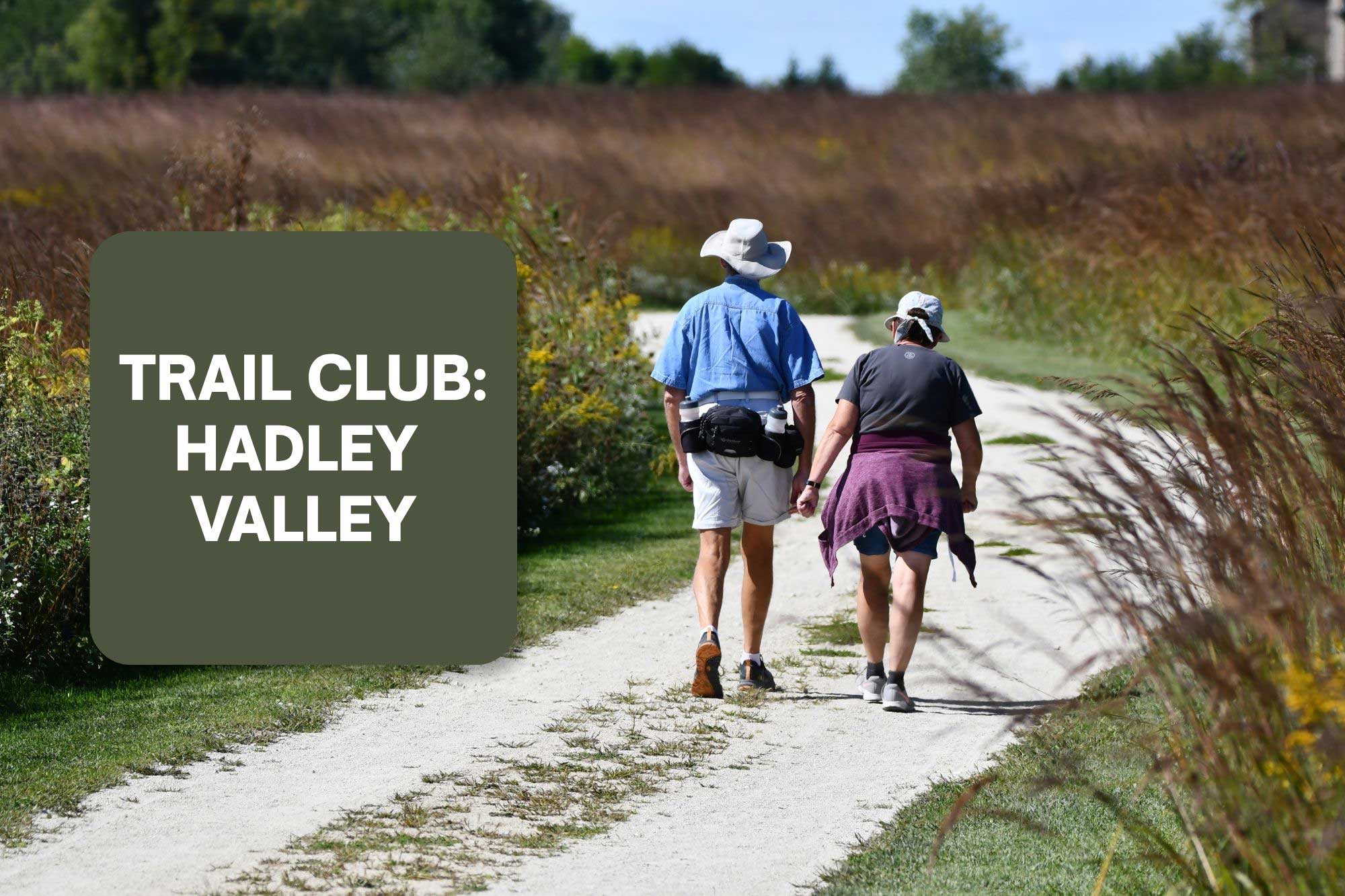 Trail Club: Hadley Valley logo next to two people walking a trail.