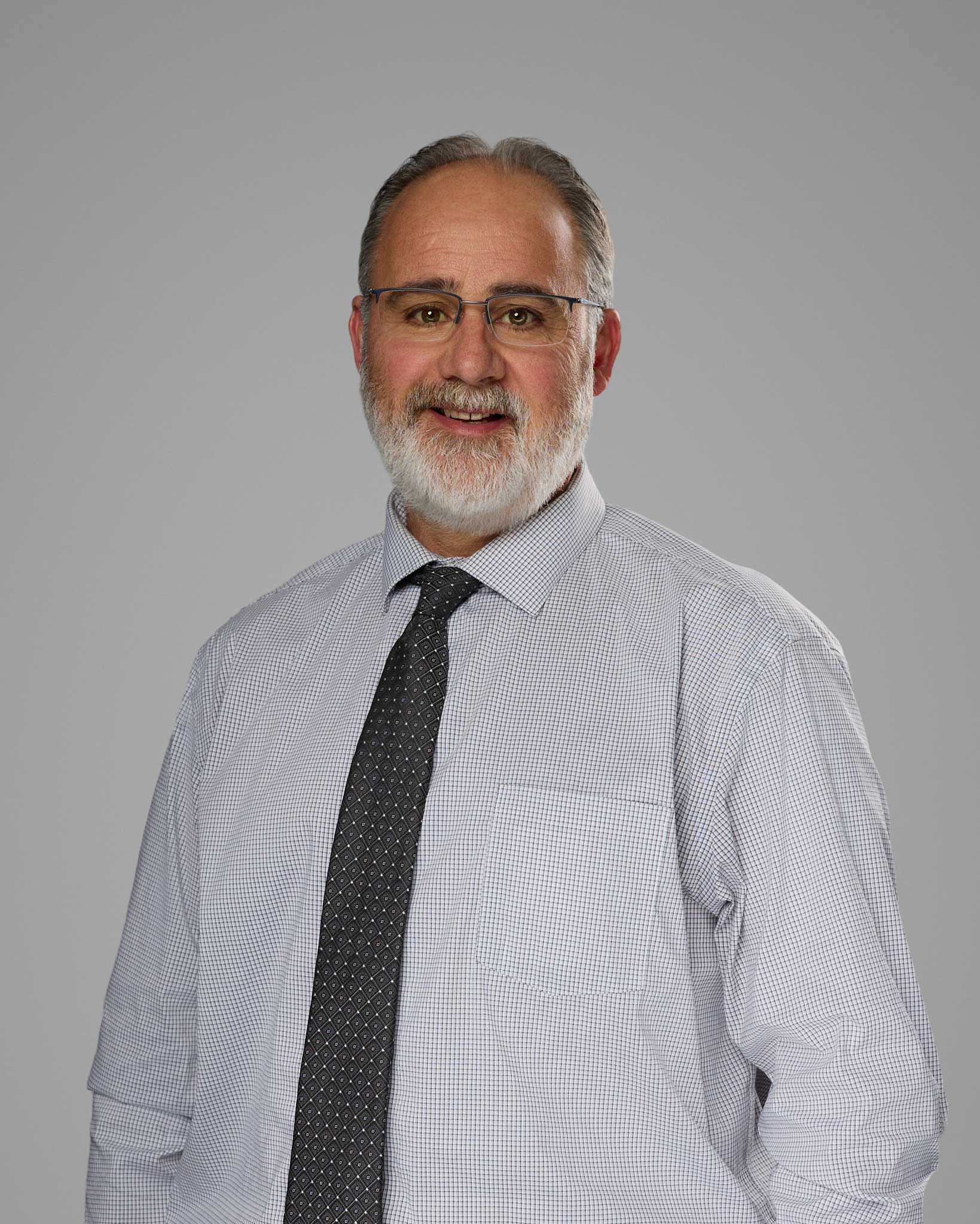 a man wearing a tie and glasses