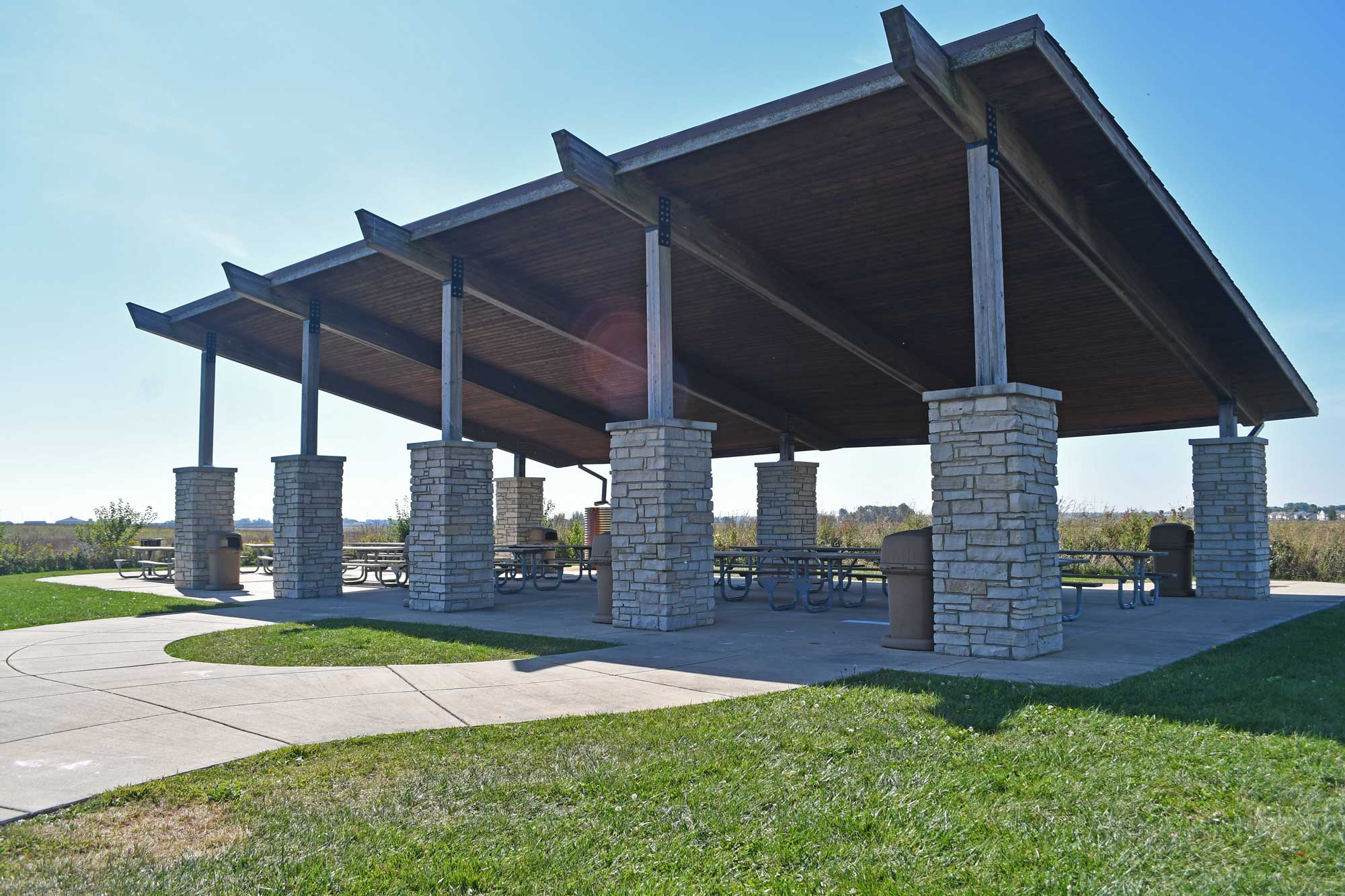Shelter with tables with the sky in the background.