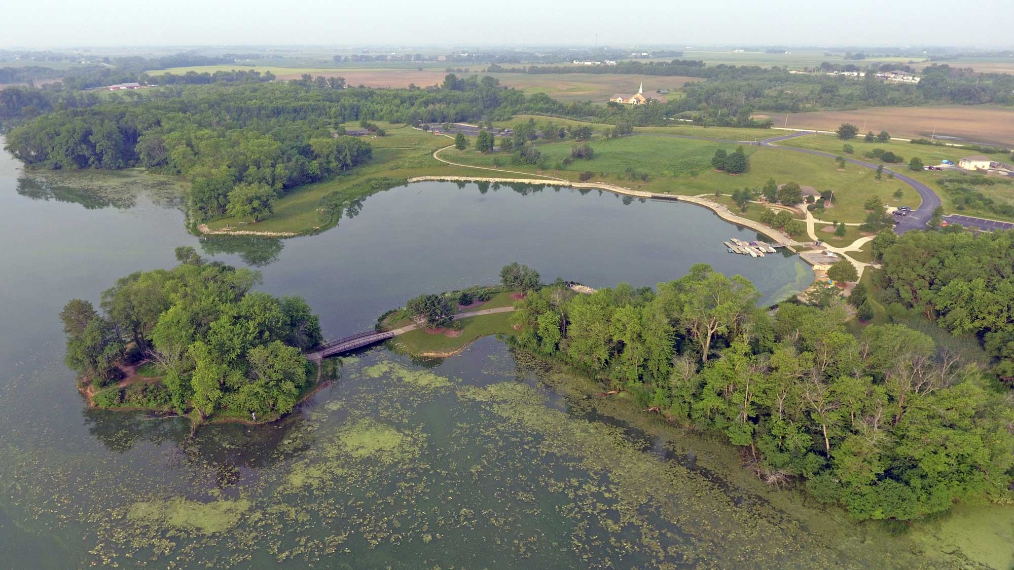 Aerial view of Monee Reservoir with water and trees in view.