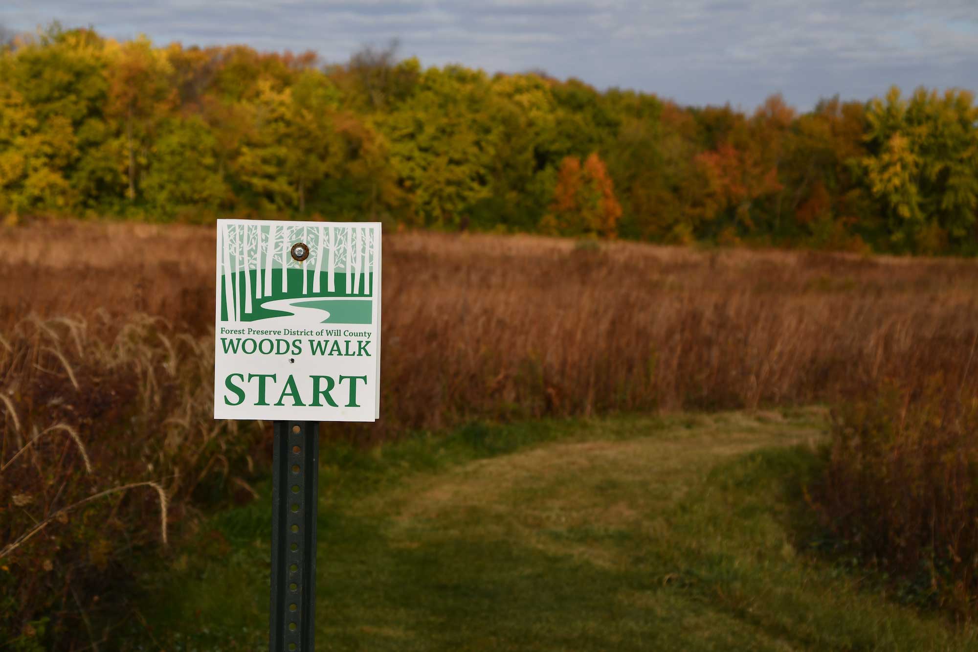 A sign that says "woods walk"