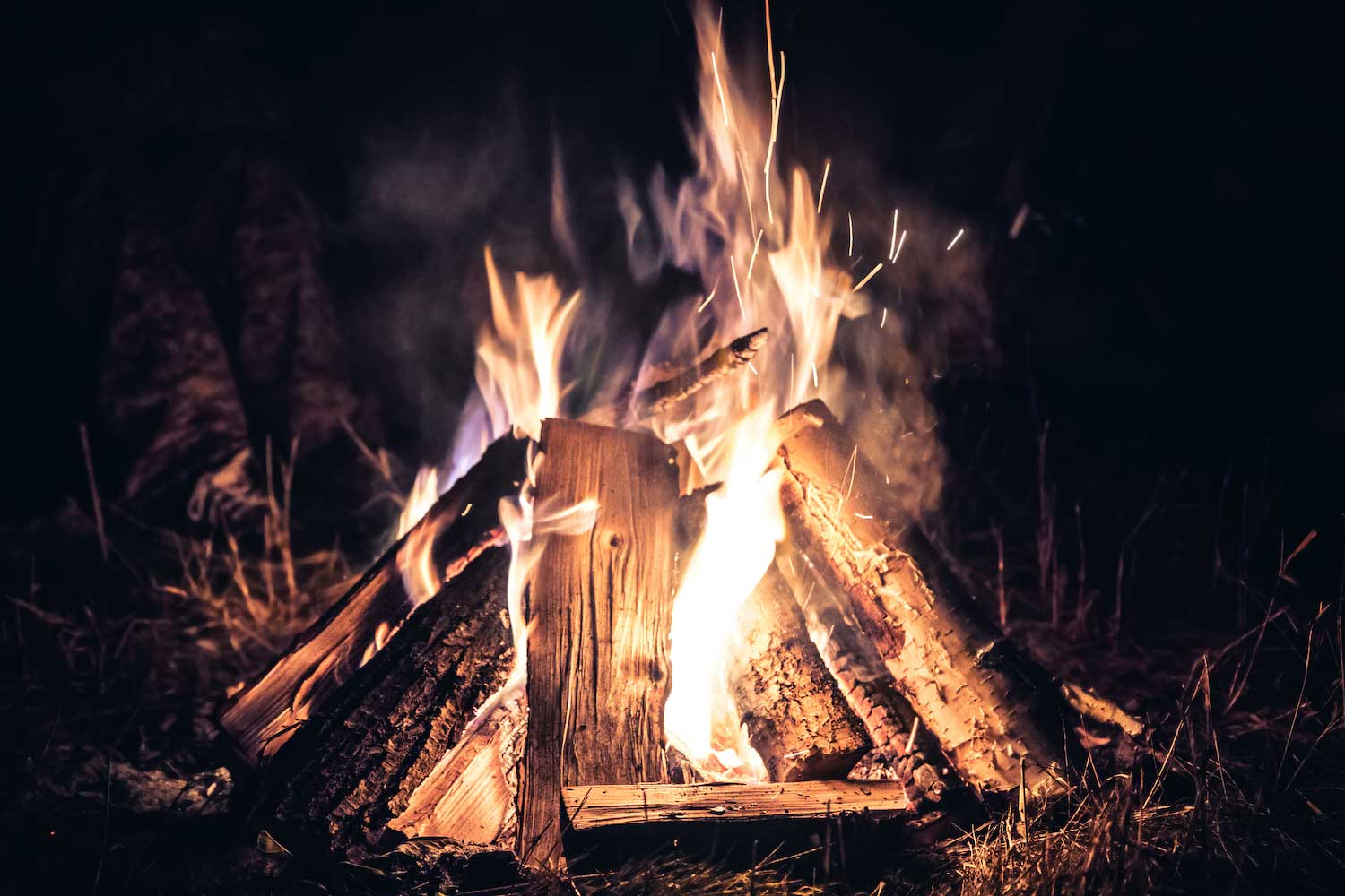 A campfire burning at night.