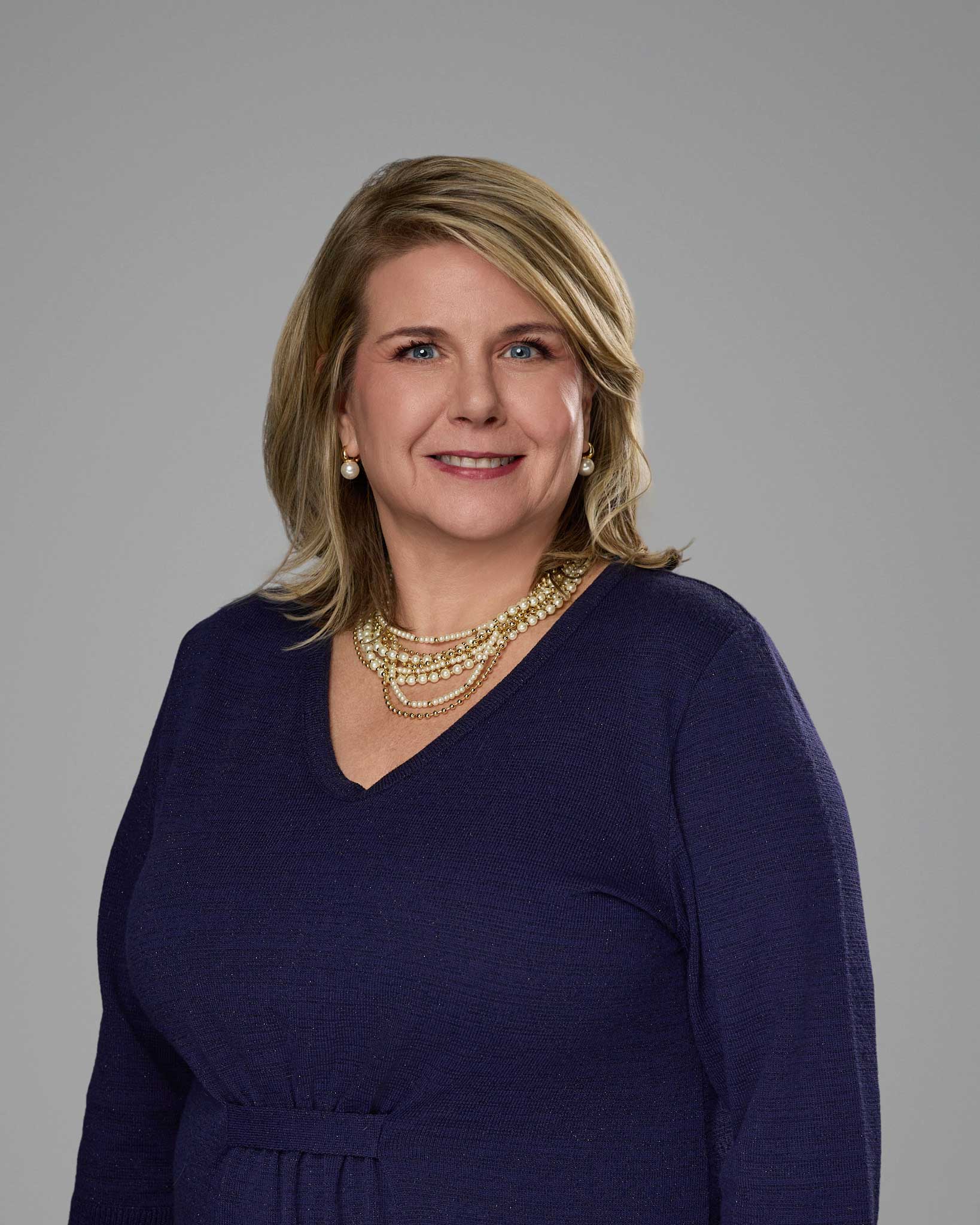 a woman wearing a blue sweater