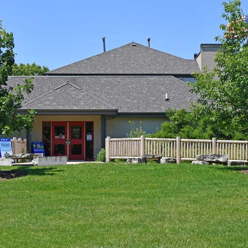 The exterior of a visitor center in summer.