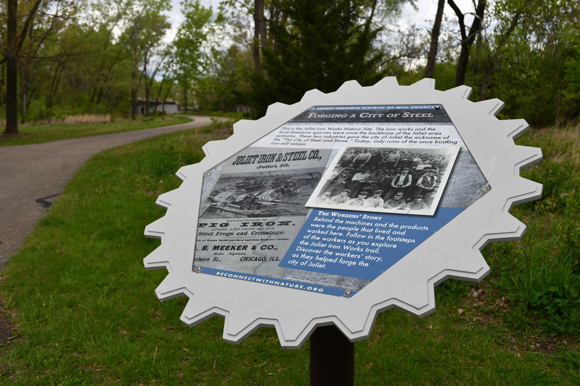 An interpretive sign detailing the work done at the sight of an old steel mill.