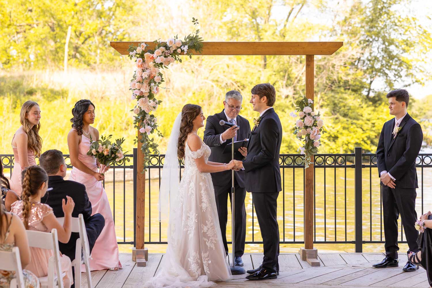 Couple standing at the front of a wedding during the ceremony.