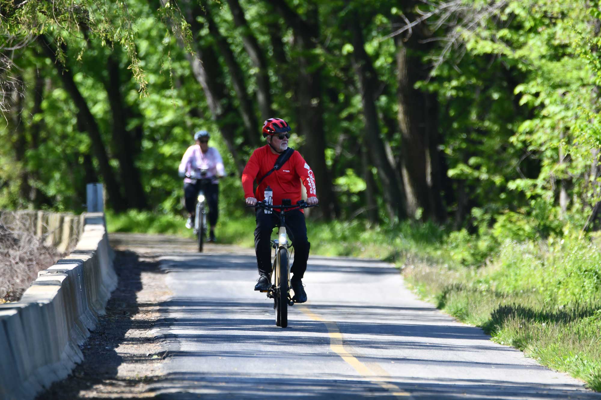 a man riding a bike on a road