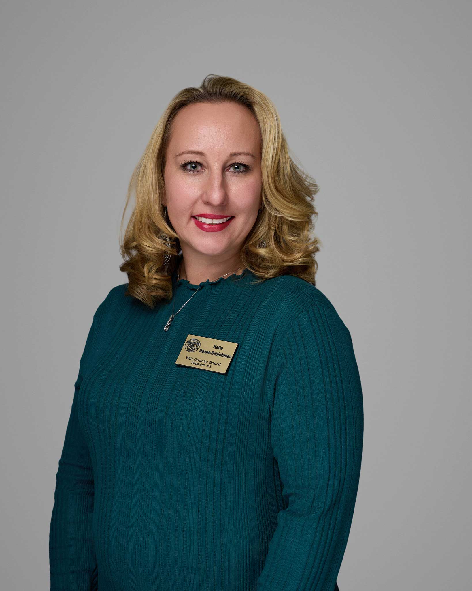 a woman wearing a green sweater
