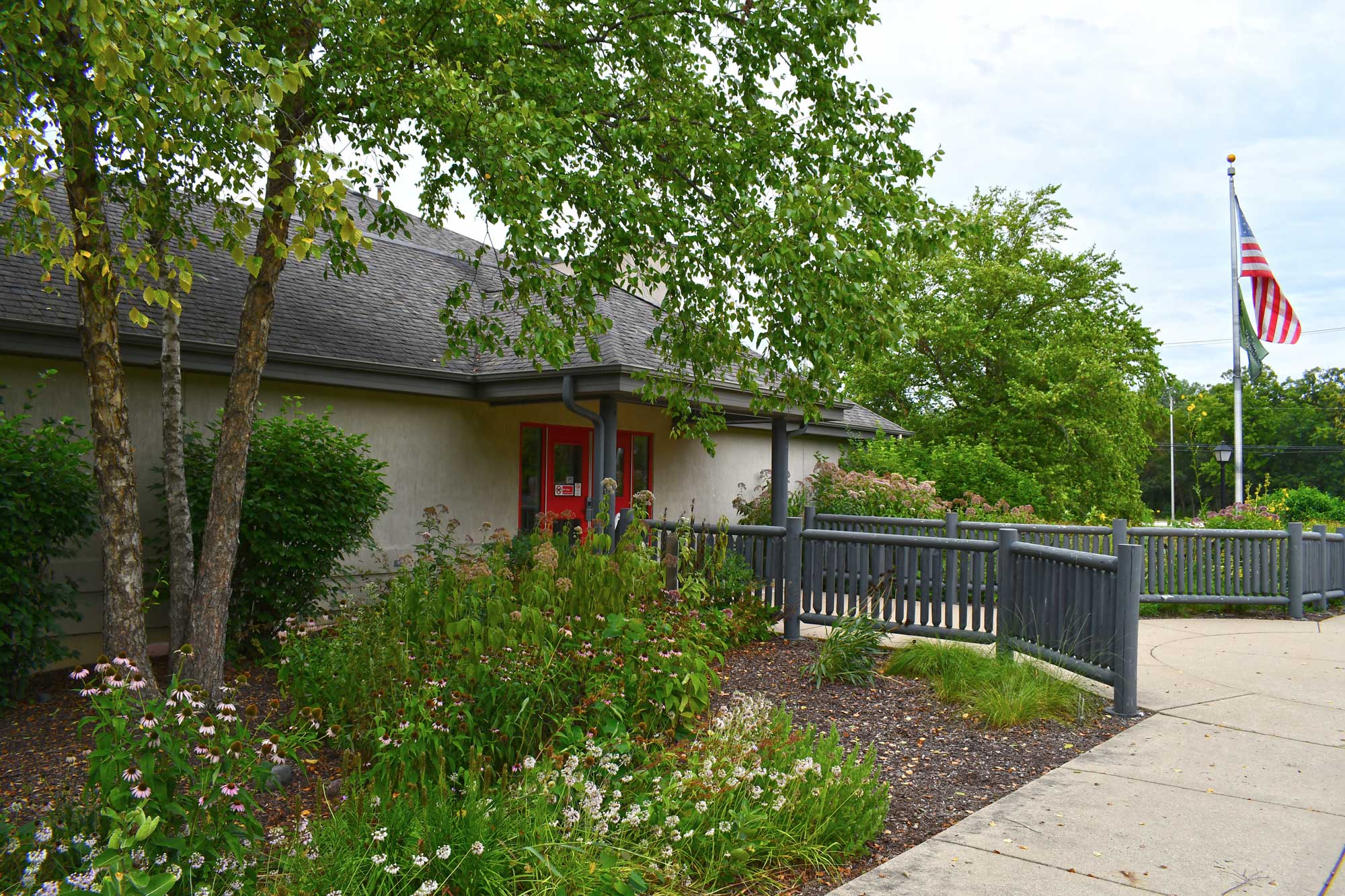 Outside of Isle a la Cache Museum with trees and vegetation in the foreground.