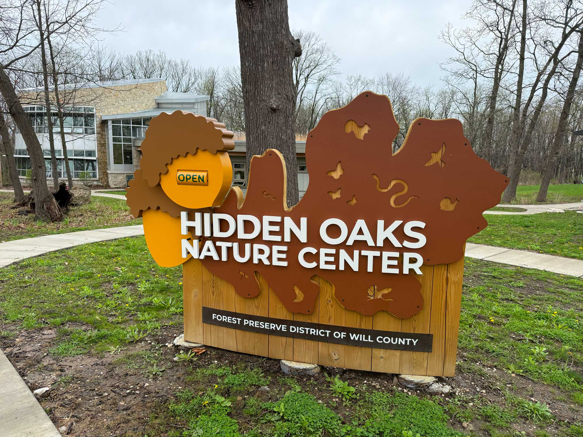 Nature center sign in front of building.