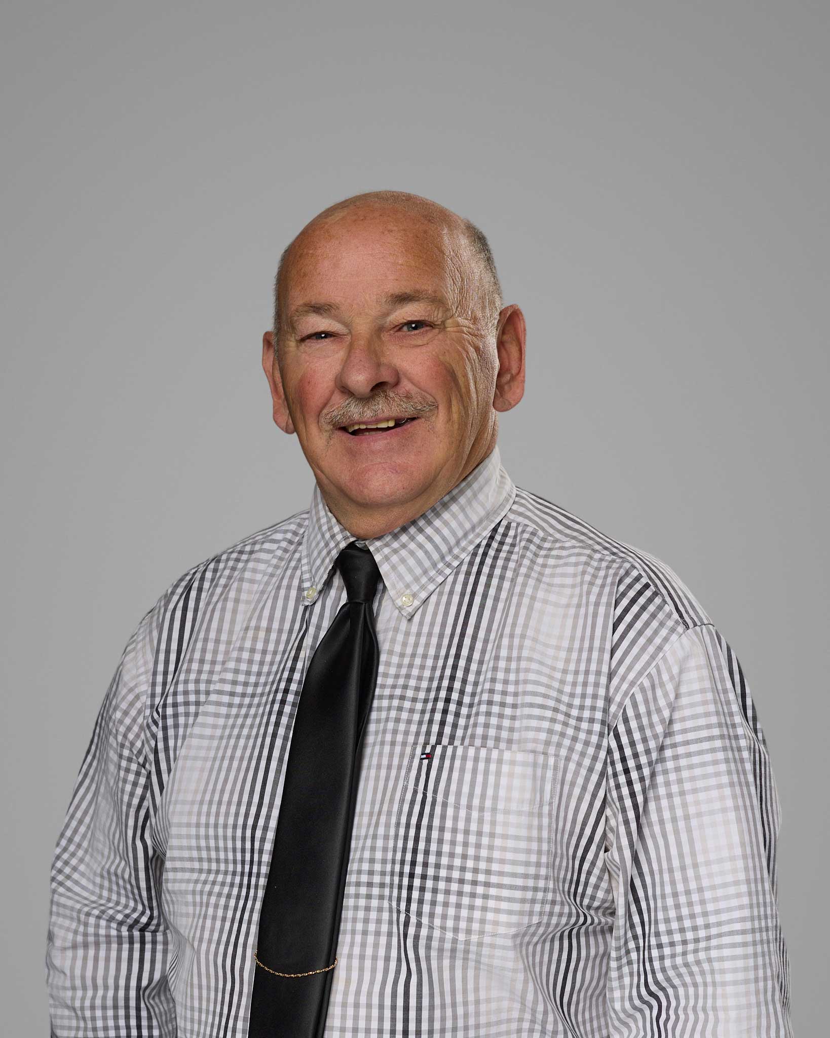 a man wearing a tie and a plaid shirt