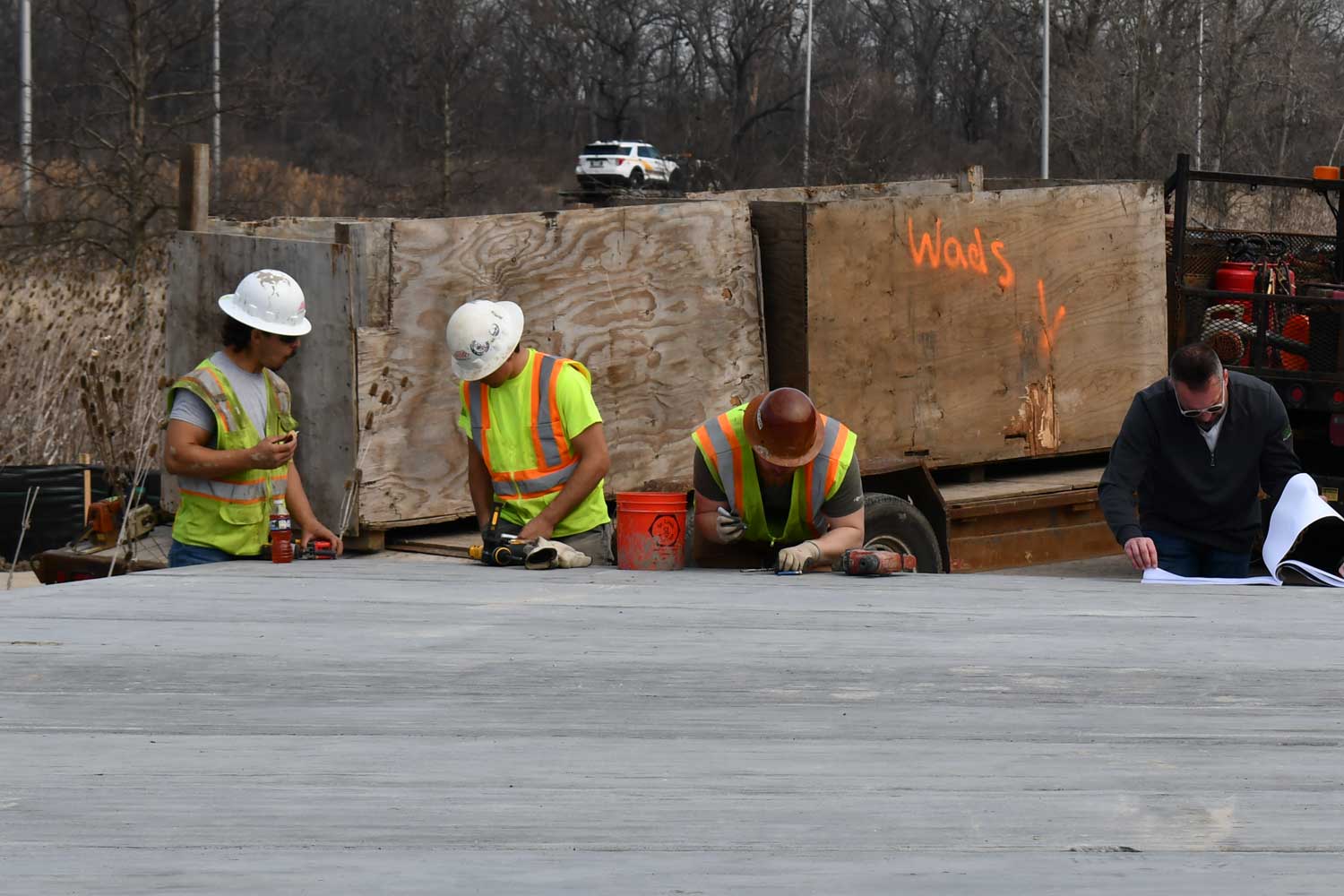 Construction workers going over construction plans.