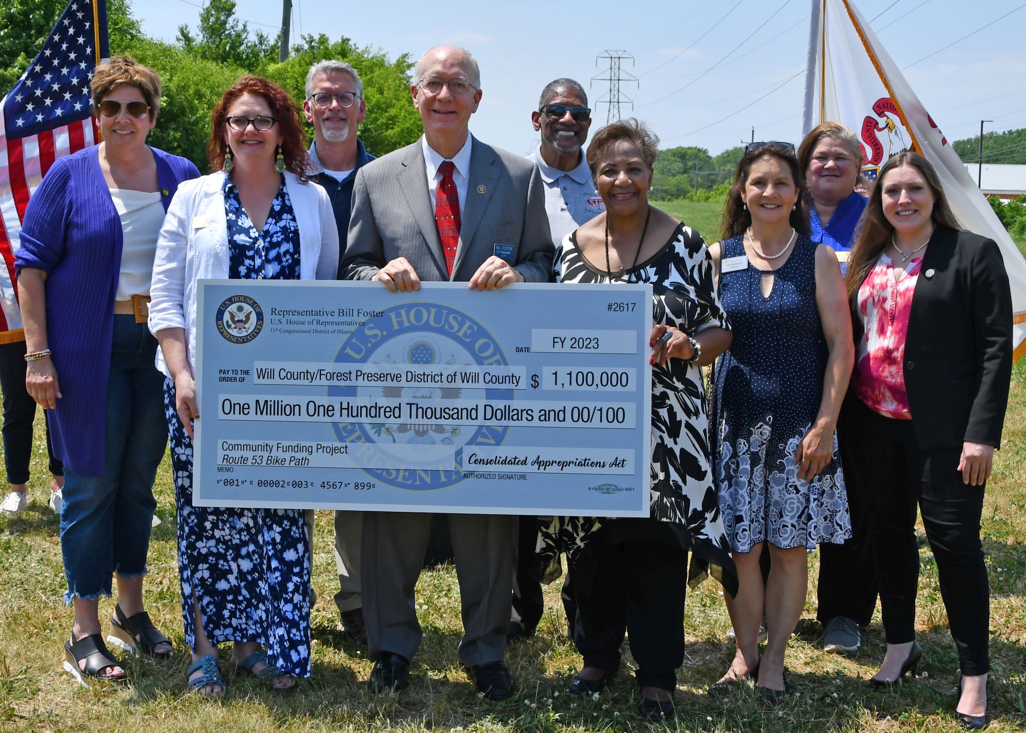 Officials holding an oversized check.