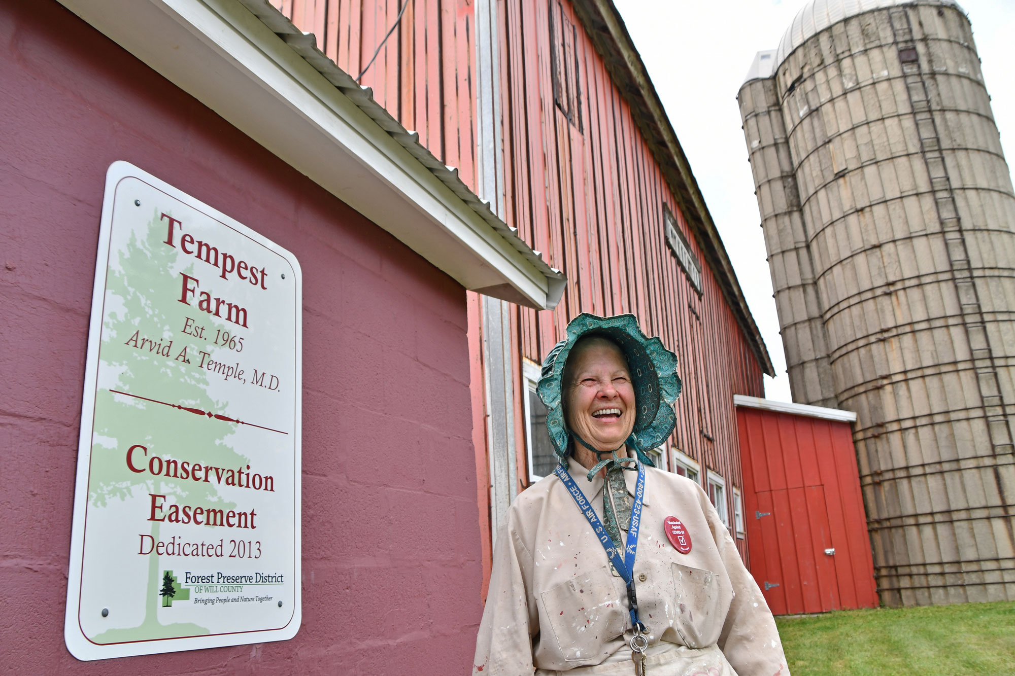 Woman standing outside old barn