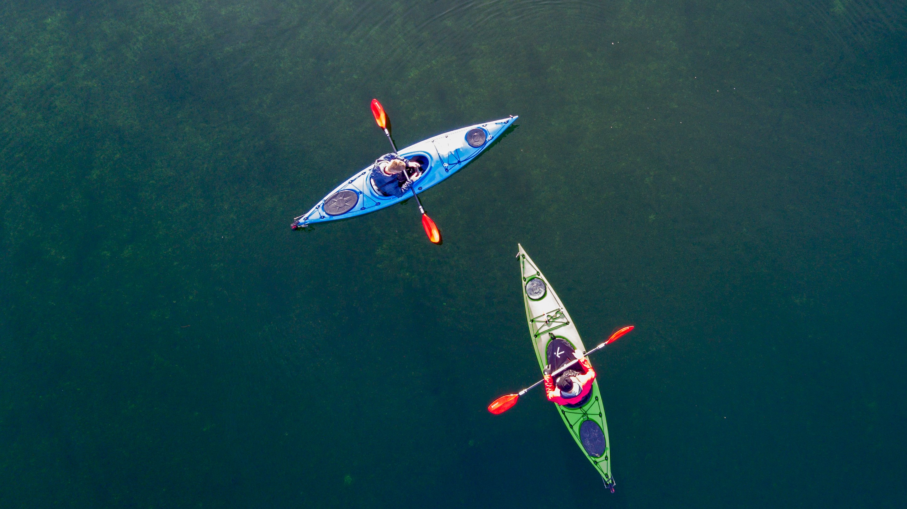 Aerial view of two kayakers out on the water.