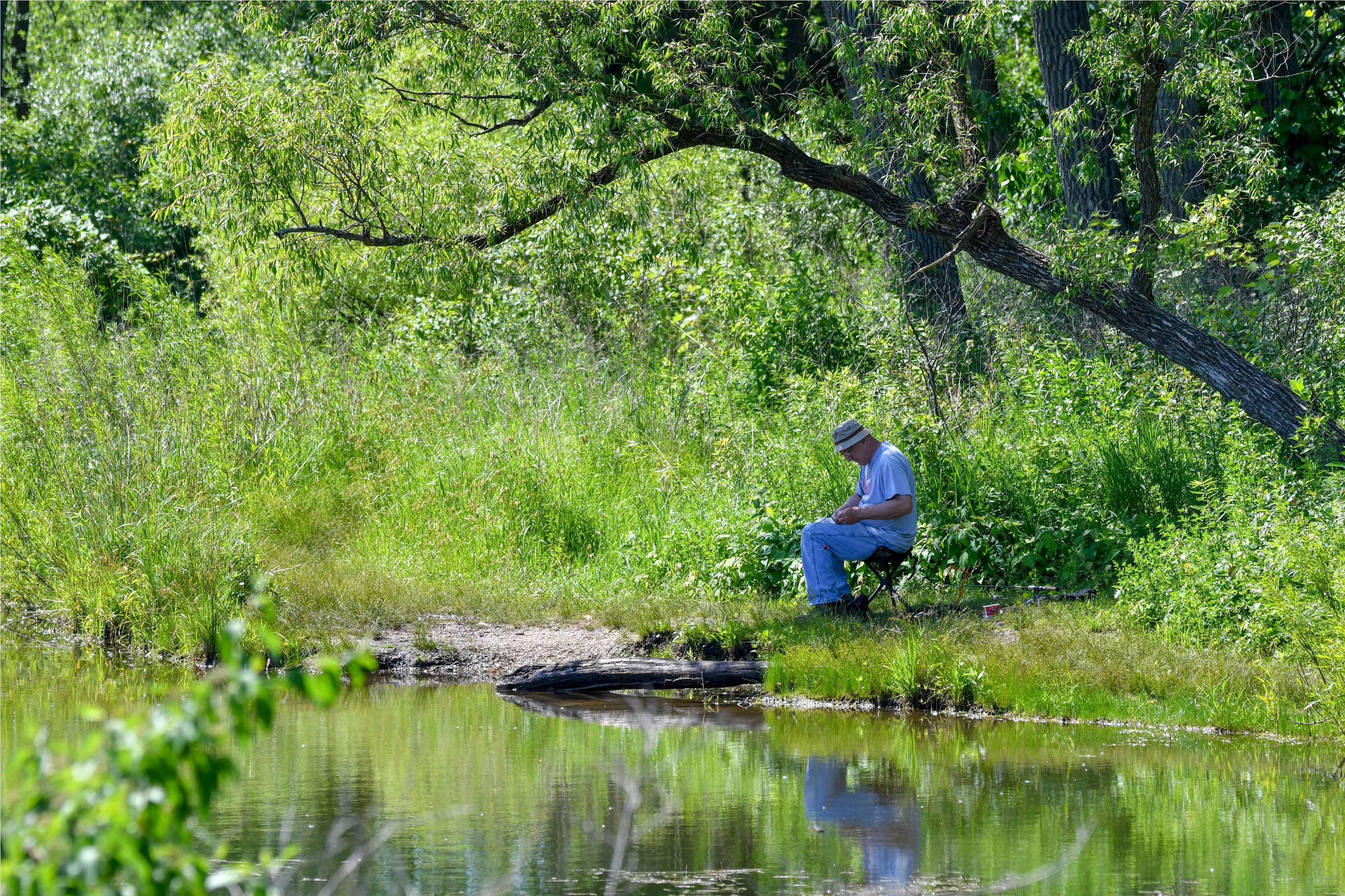 A man fishing at Rock Run Preserve.