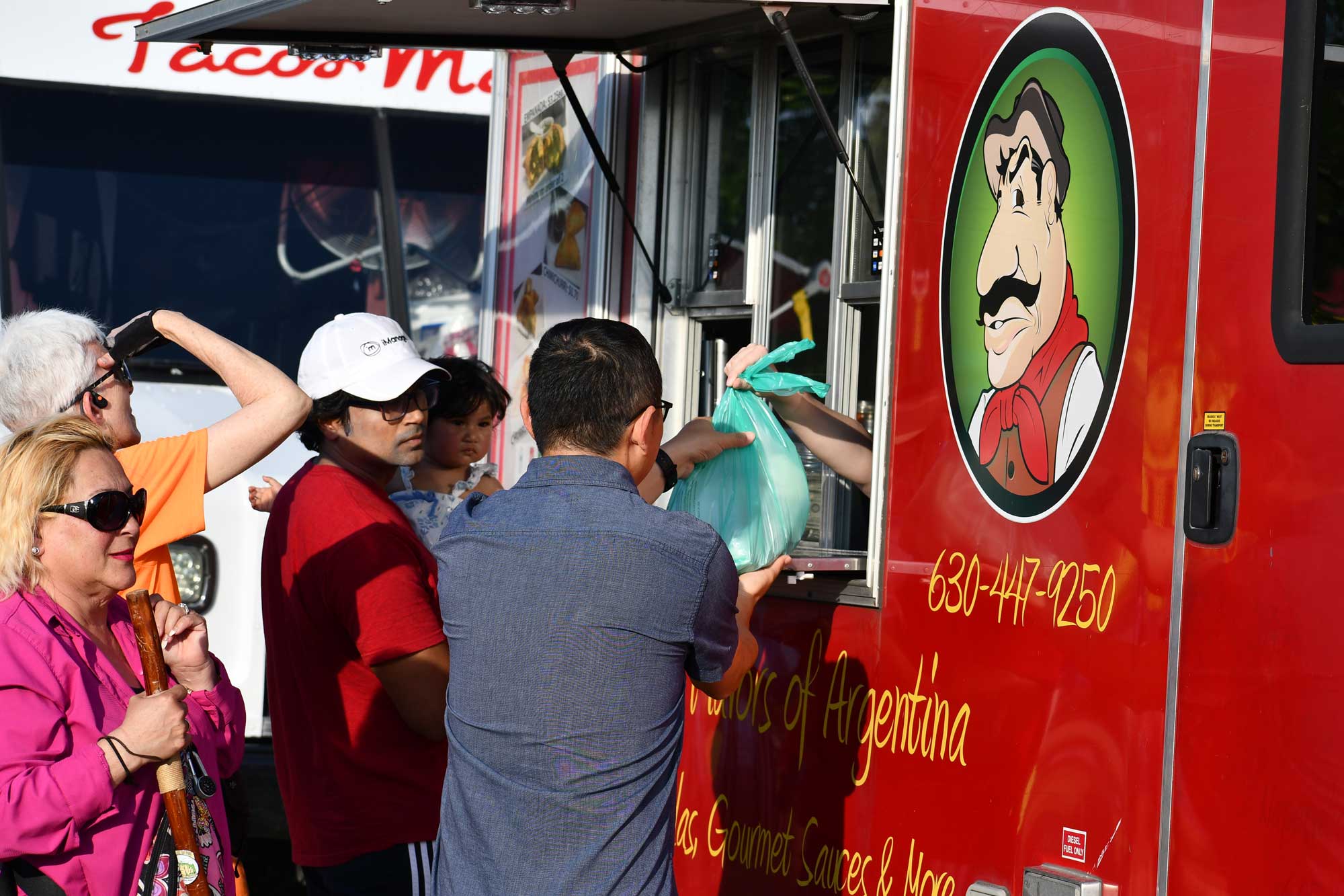 People order food from a mobile food truck.